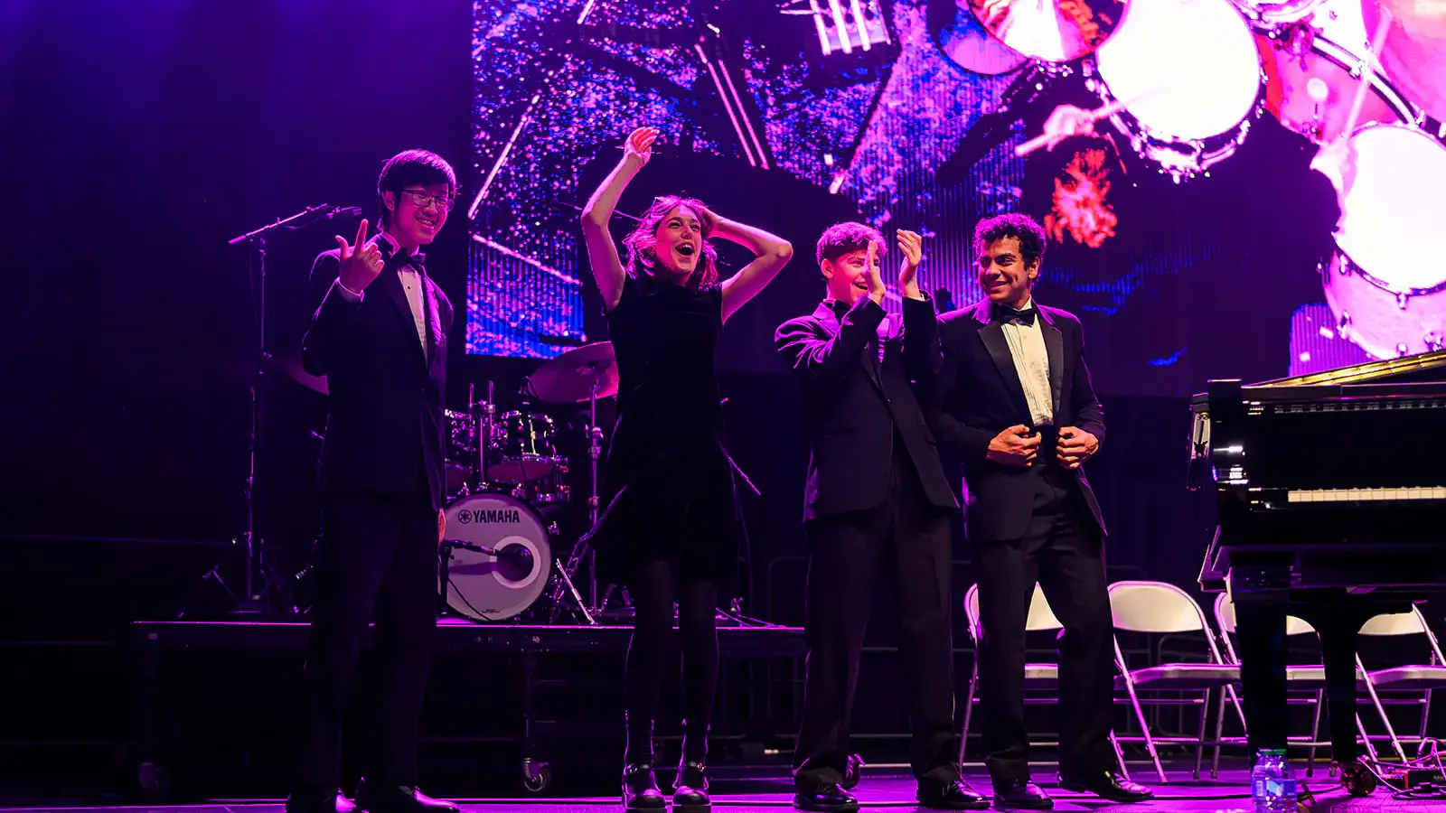 Four award winners on stage, celebrating