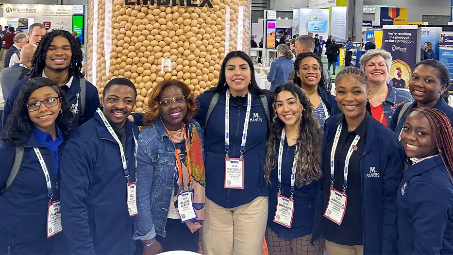 A group photo of men and women at a conference