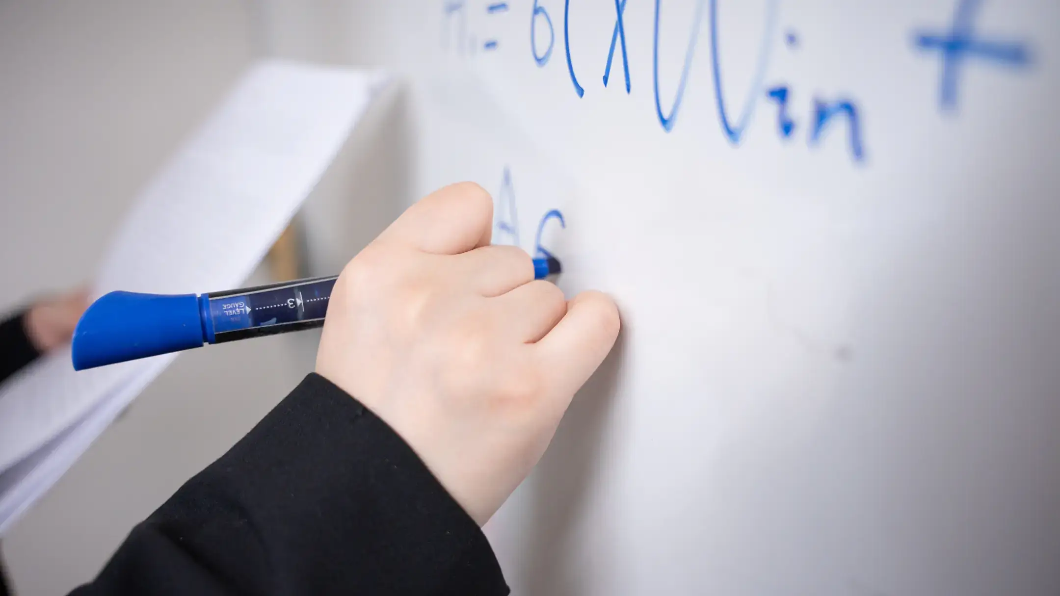 University of Idaho Mathematics and Statistical Science faculty Tiantian Yang uses a white board to work on mathematical models of diseases that can reduce health care costs and that can be easy to interpret so they are trusted by healthcare workers.
