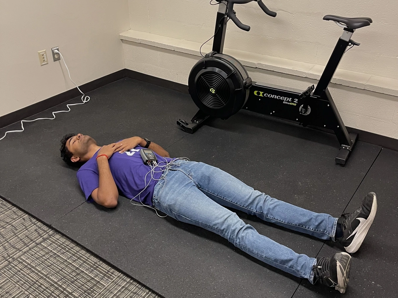Person participating in a health study lying on mat with monitoring device