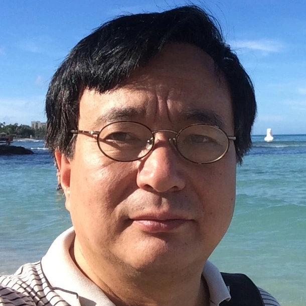A man taking a selfie in front of the ocean