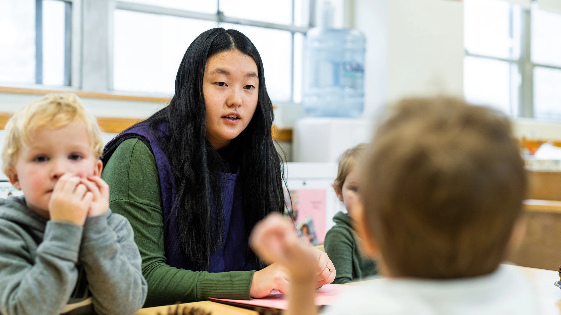 student teacher interacting with classroom children