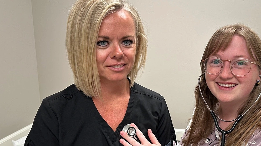 person examining another person with stethoscope
