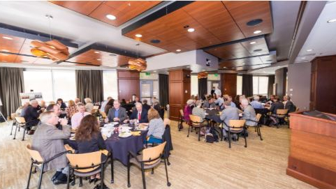 Room full of tables with participants