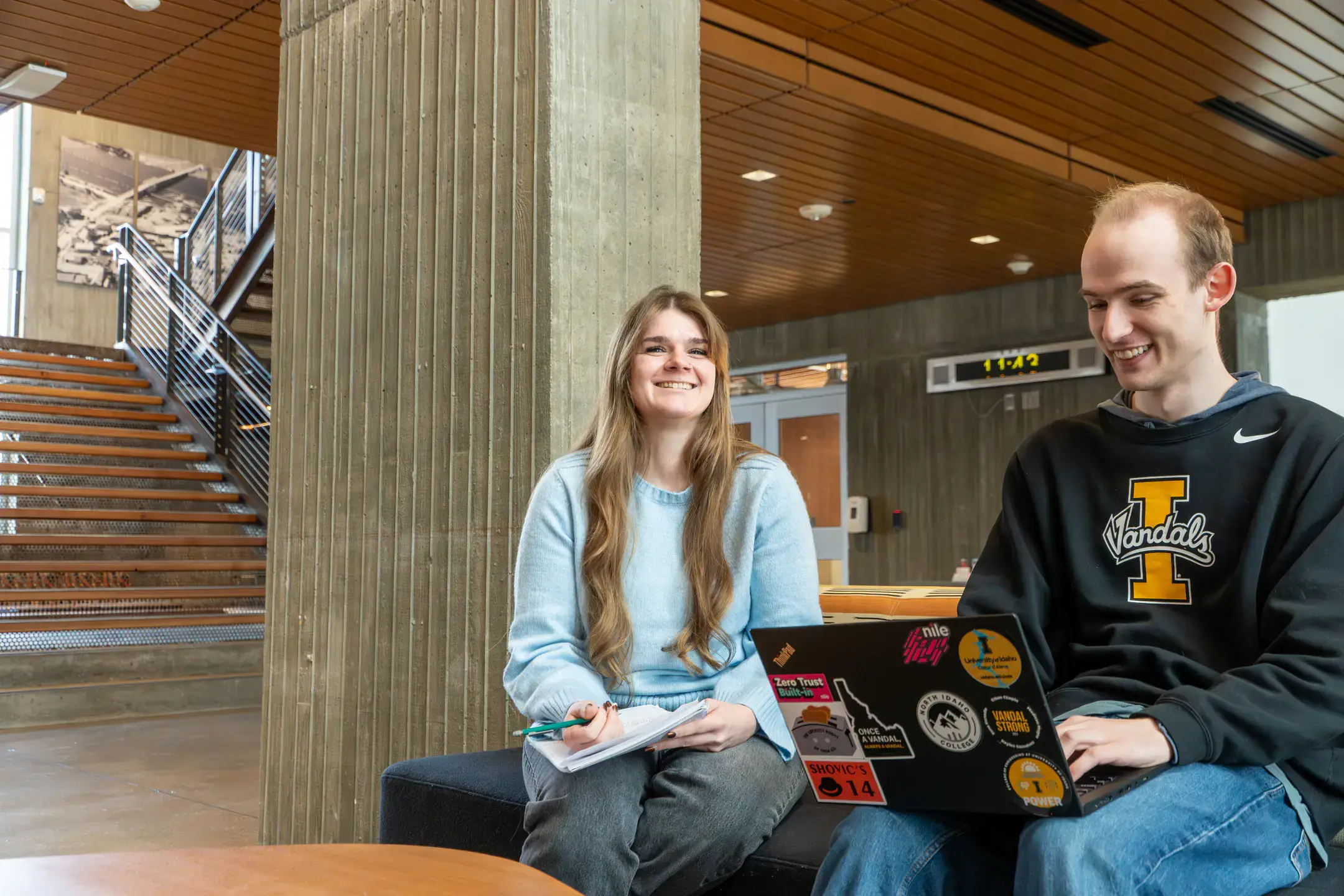 North Idaho students Jasmine Martinez and Michael Habermann share a laptop computer inside a building on NIC campus.