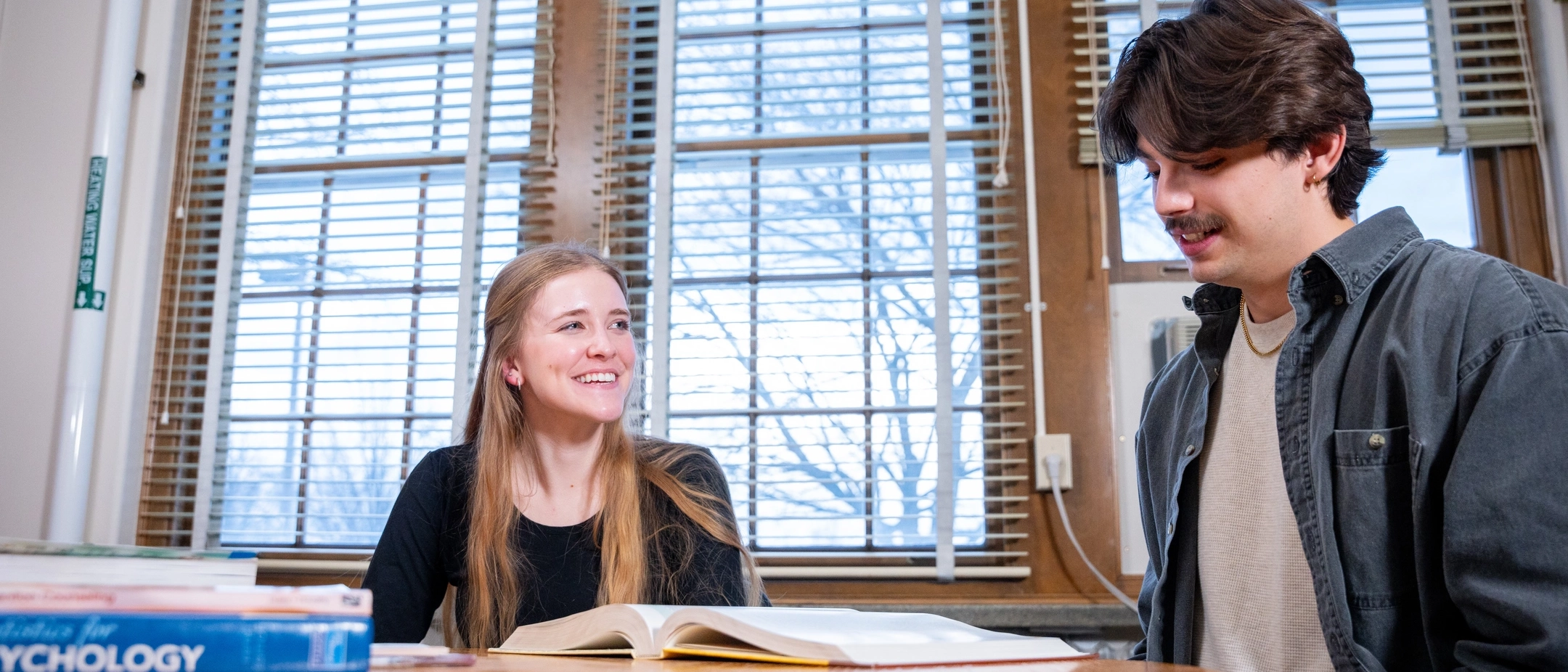 Graduate student Wade Scott and student Katelynn Kjorness collaborate researching addictions in the  Department of Psychology and Communications.