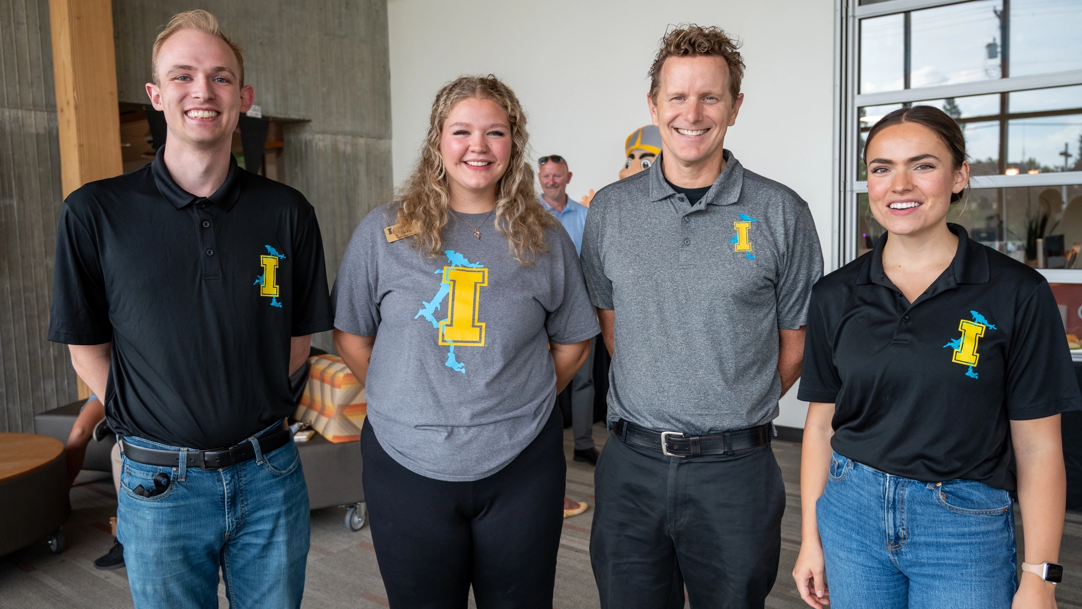 four people standing outside a building