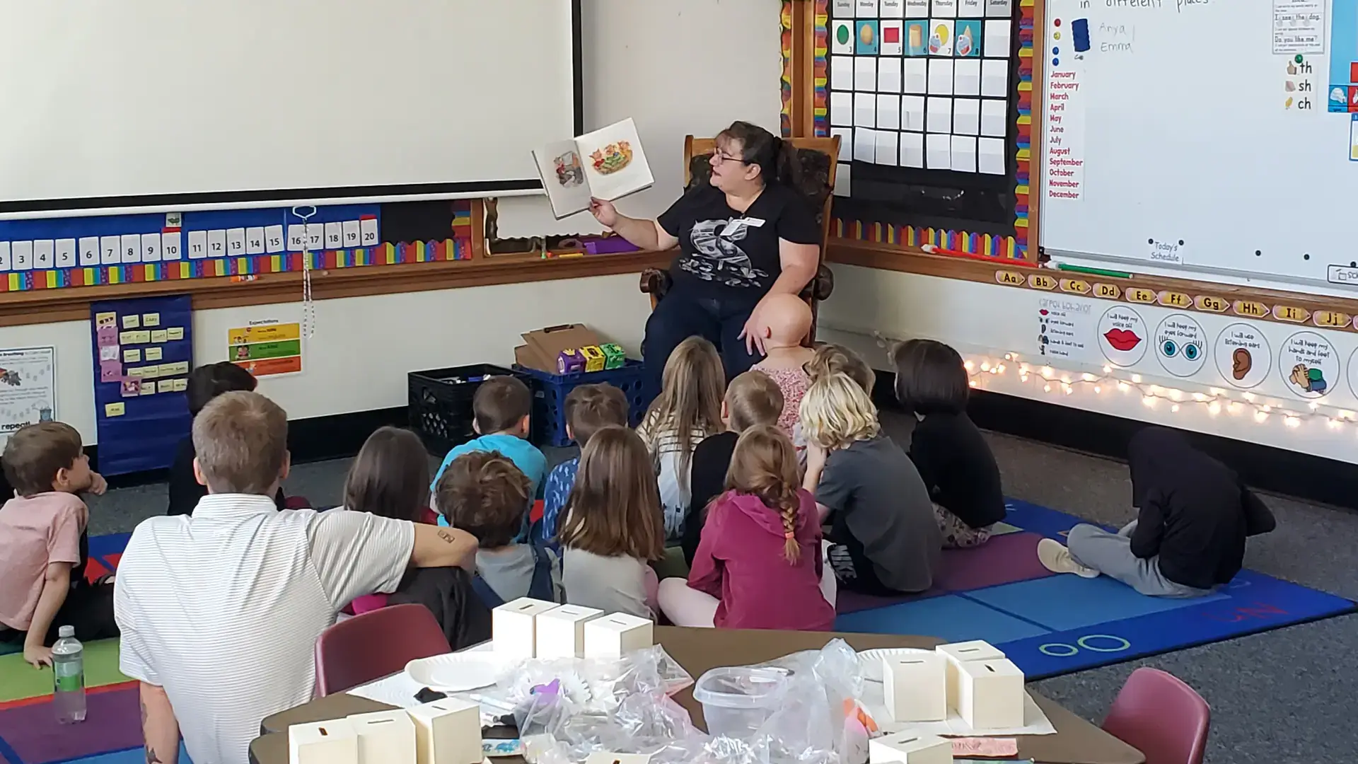 Children listen attentively to adult reader.