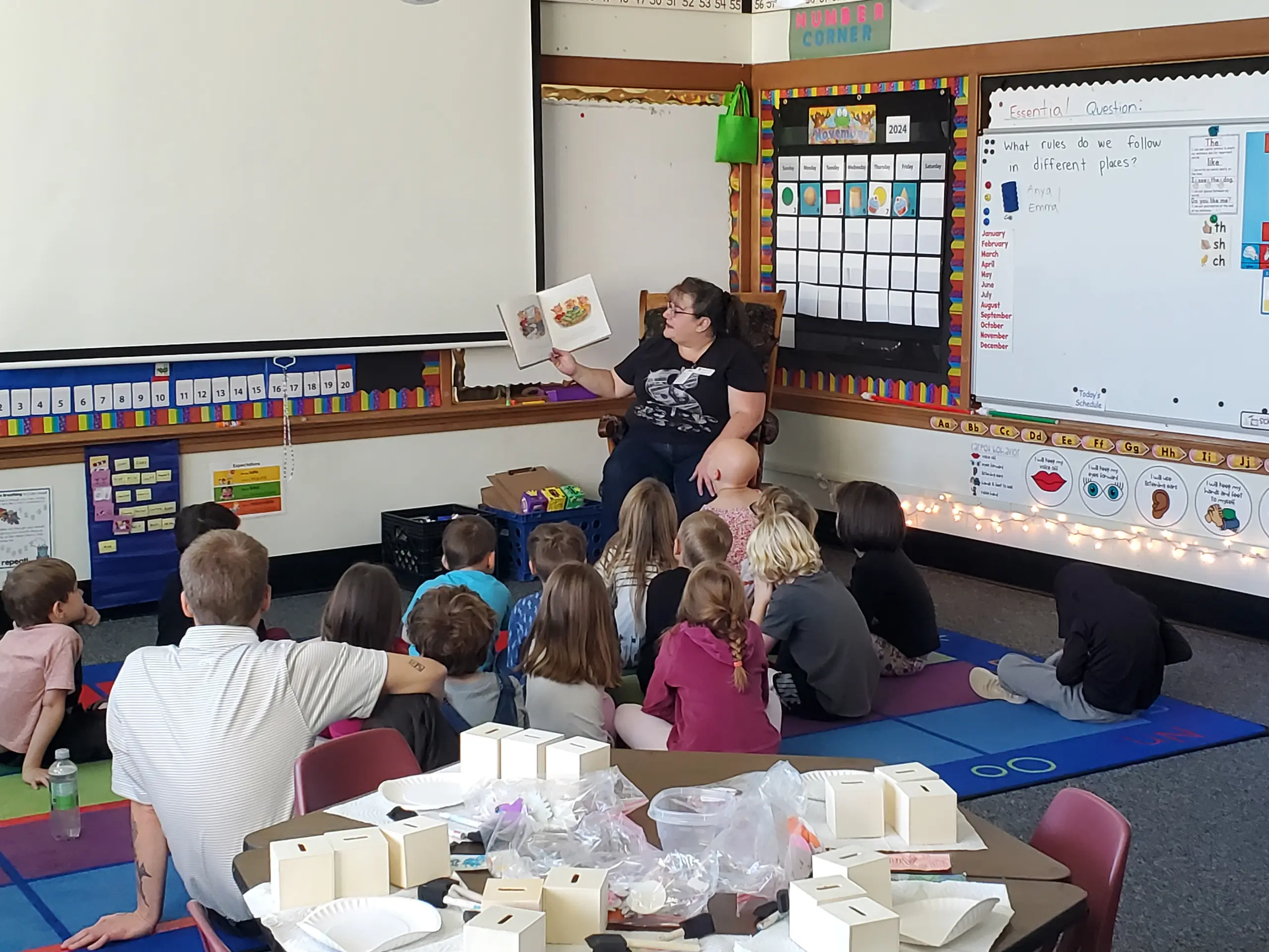 Children listen attentively to adult reader.