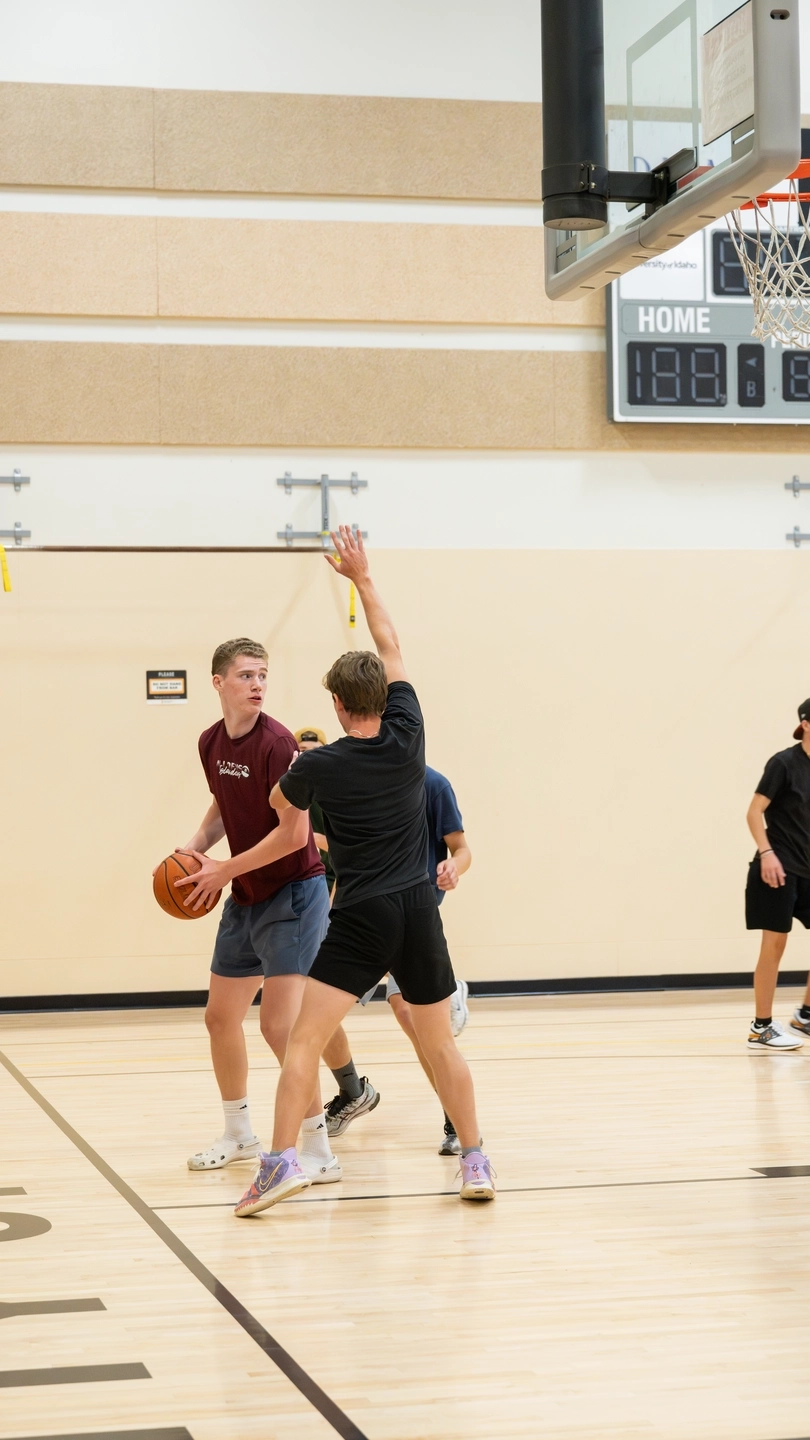 Two teams play basketball on the MAC Court in the Student Recreation Center.