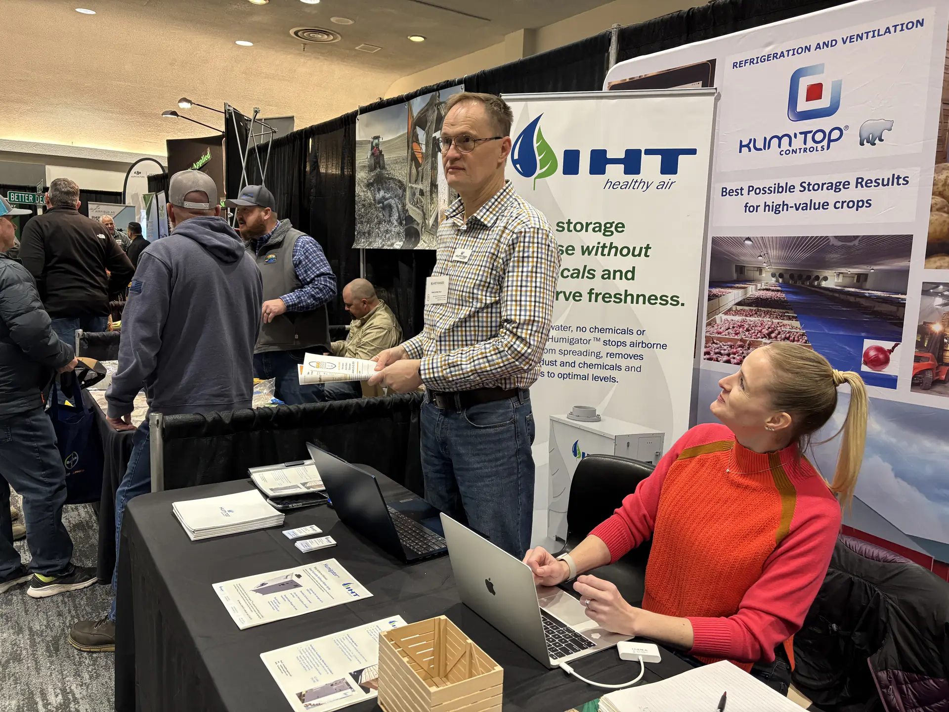 A man stands behind a table for Idaho Hydro Tech at the 57th annual Idaho Potato Conference.