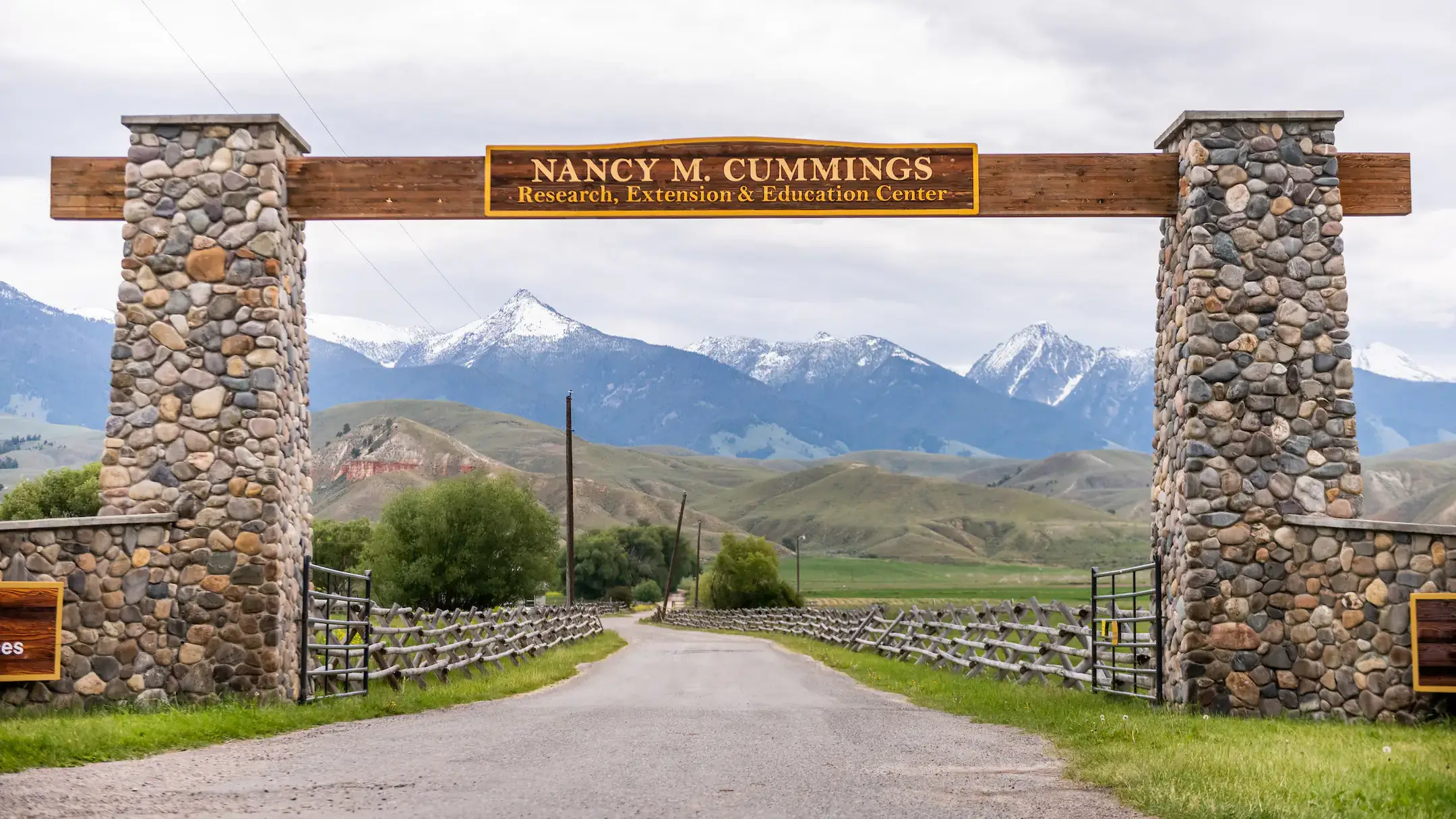 The Nancy M. Cummings Research, Extension and Education Center massive entrance. Showing a beautiful landscape of snow topped mountains in the background.