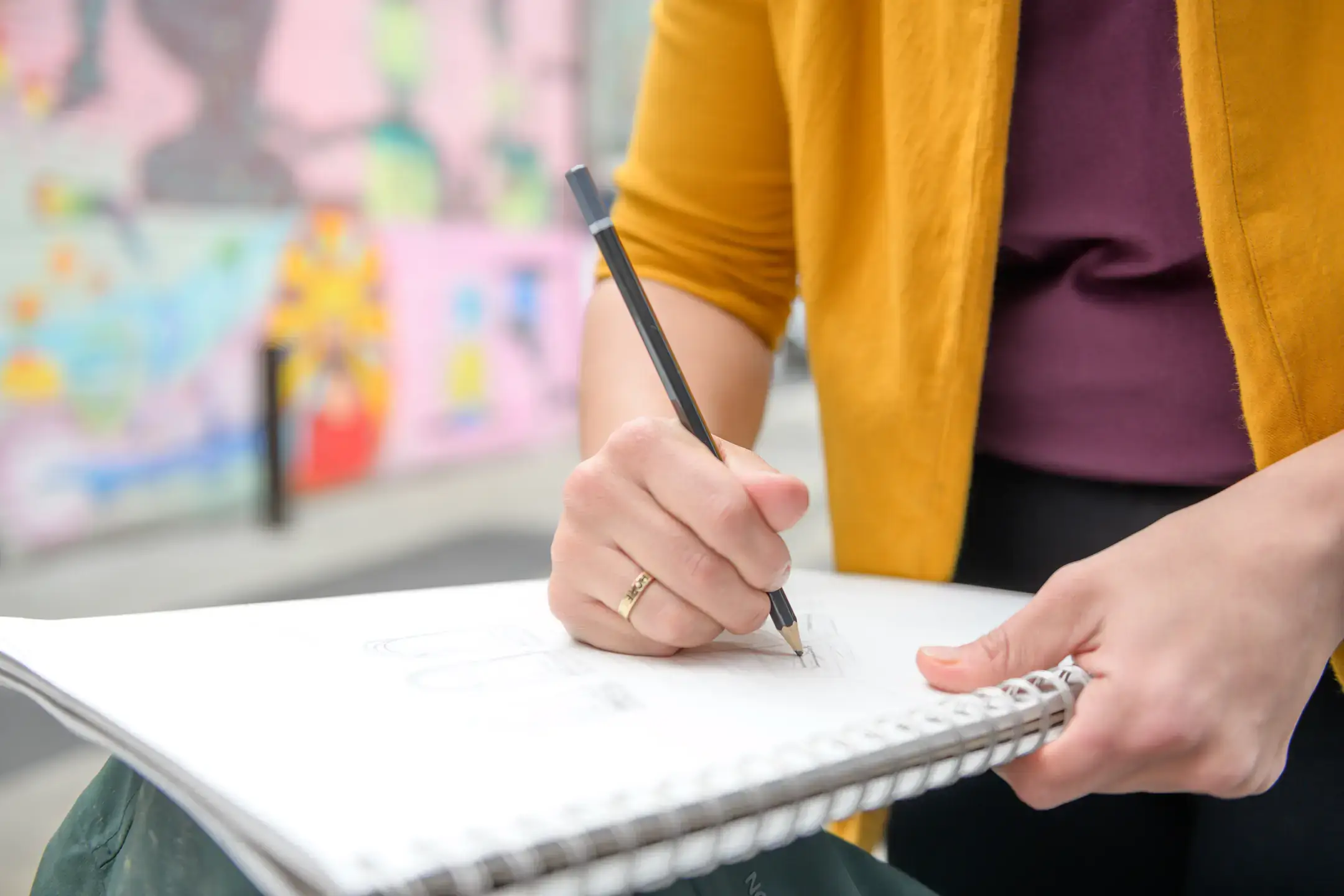 A student designing a room with pencil and paper