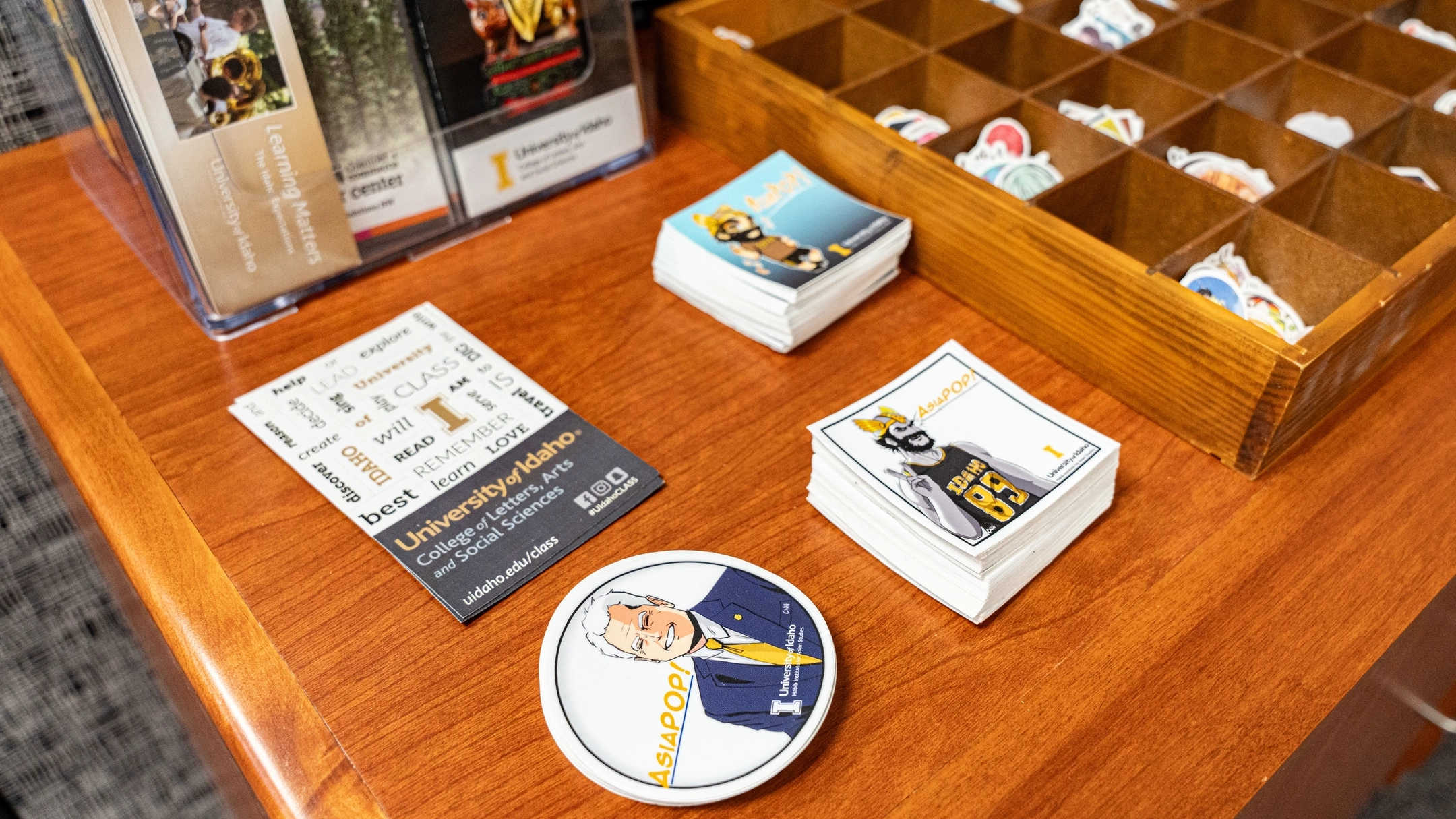 Pamphlets and papers sitting on a wooden desk