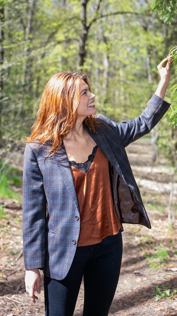 Celilo Miles smiles while touching a tree