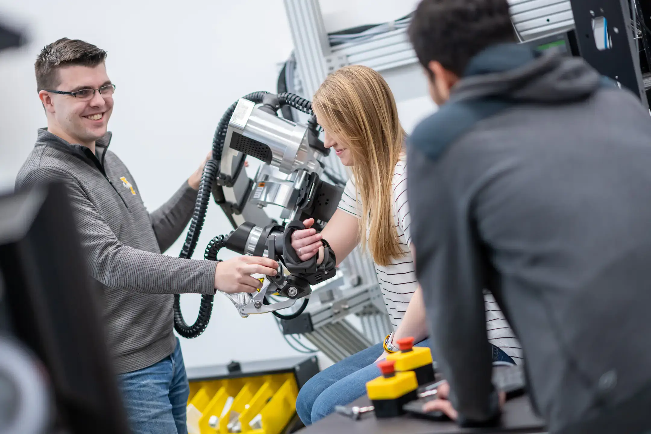 University of Idaho College of Engineering students and faculty working with therapeutic robots made to assist in physical therapy.