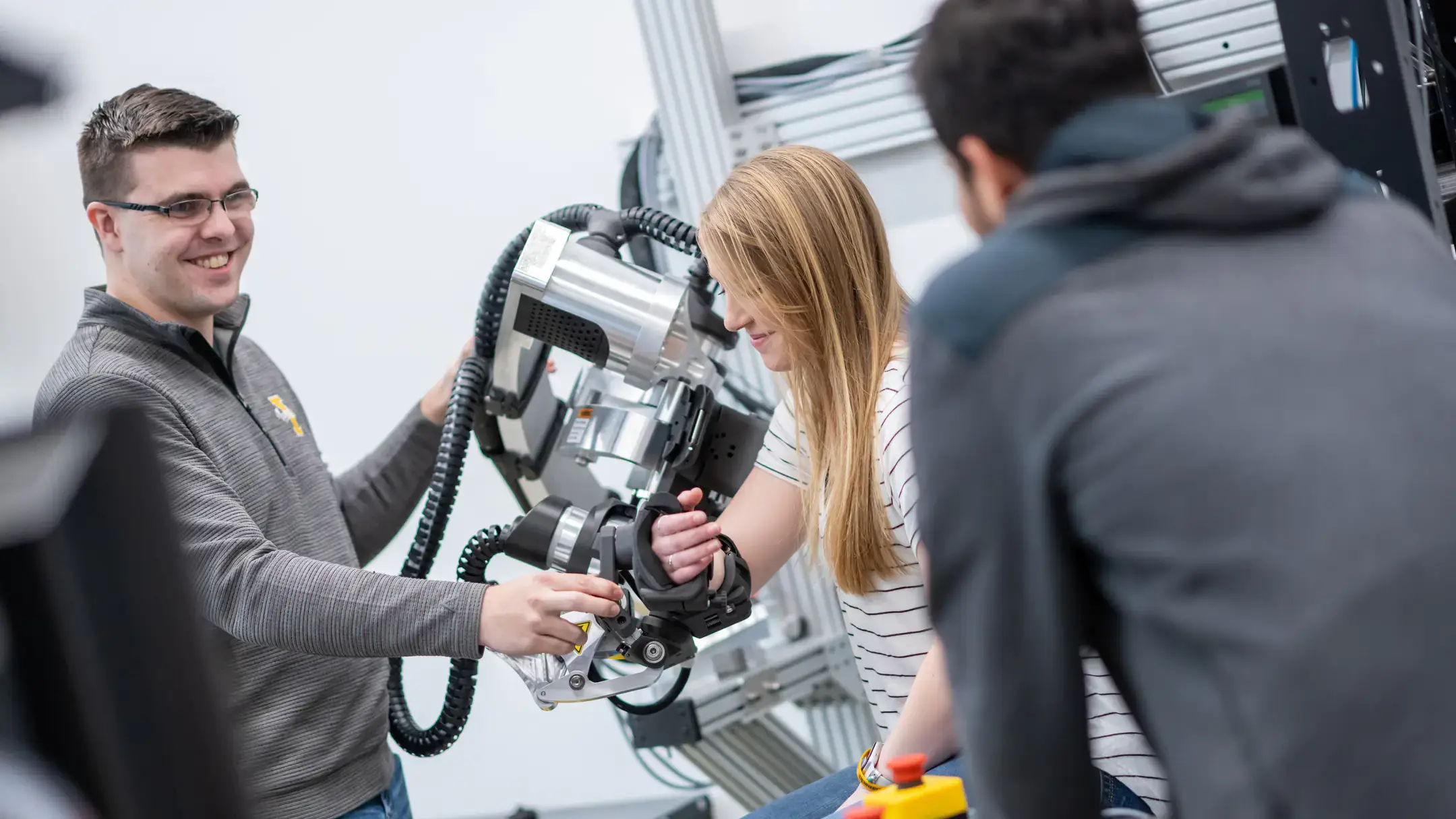 University of Idaho College of Engineering students and faculty working with therapeutic robots made to assist in physical therapy.