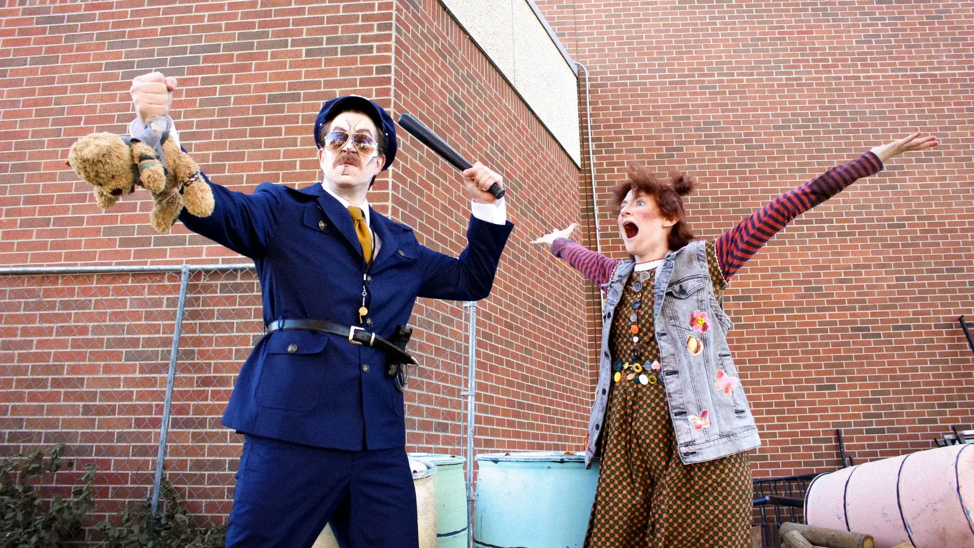 Cast members of “Urinetown” rehearse and pose in-character.