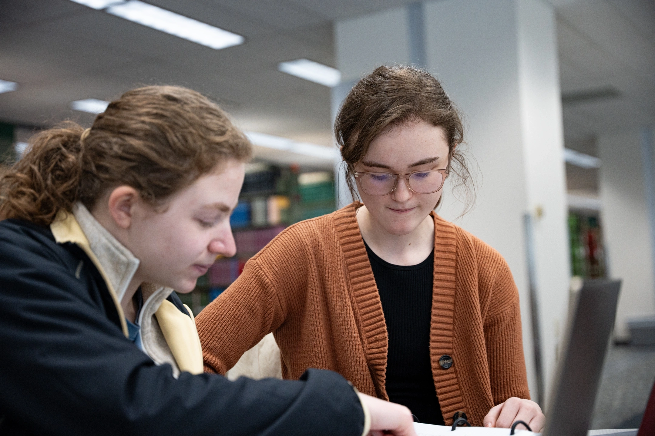 Ӱֱ campus in the winter, Students in the library.