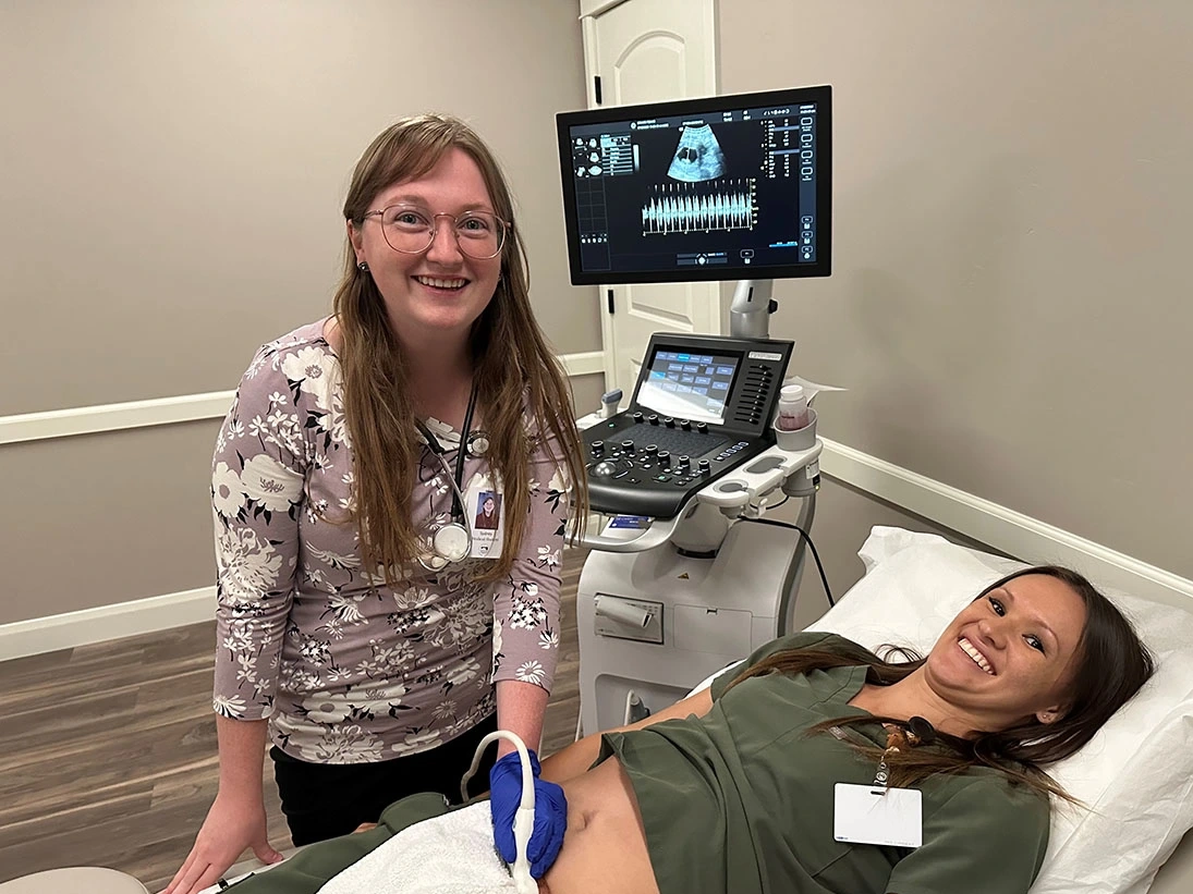 Sydney Mena practices giving a patient an ultrasound at a clinic in Rexburg