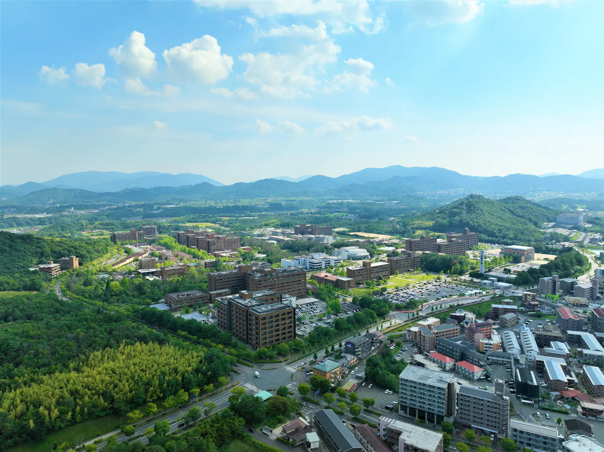 Aerial view of entire HU campus and surrounding city, mountains, and forest