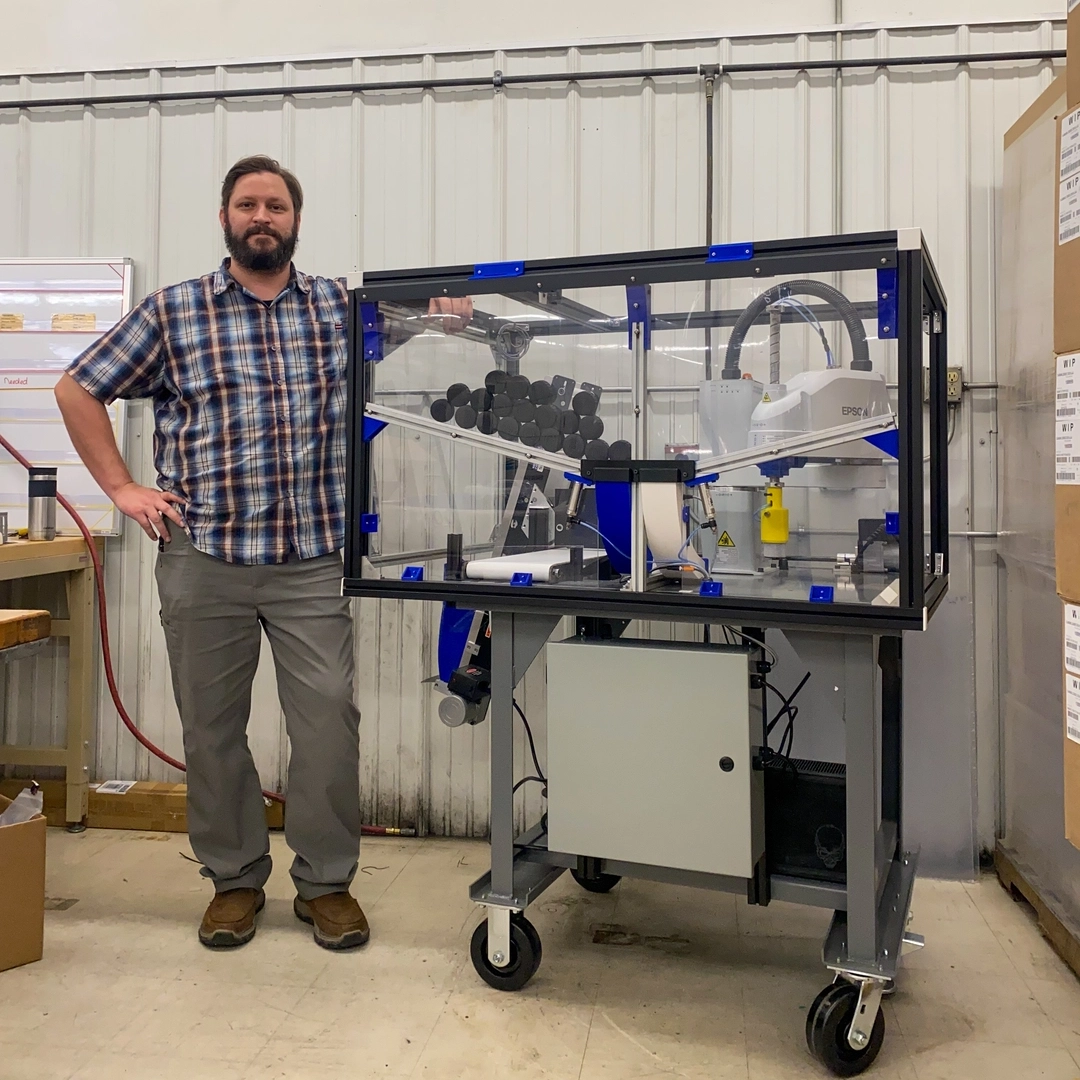 Gary Banks stands next to the device he created.