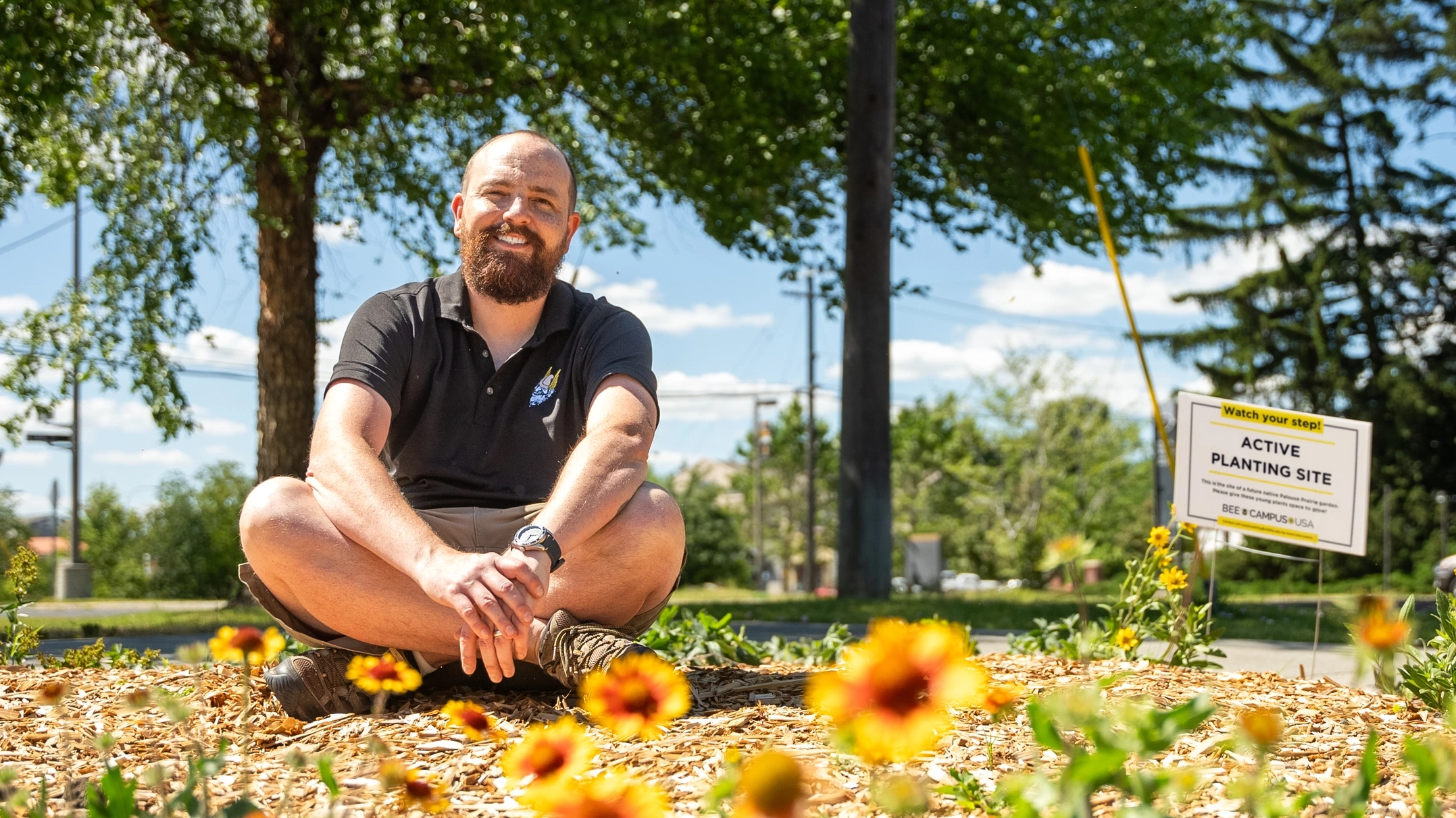 Karl Meyer sits among Palouse native habitat plants near the I-Tower.