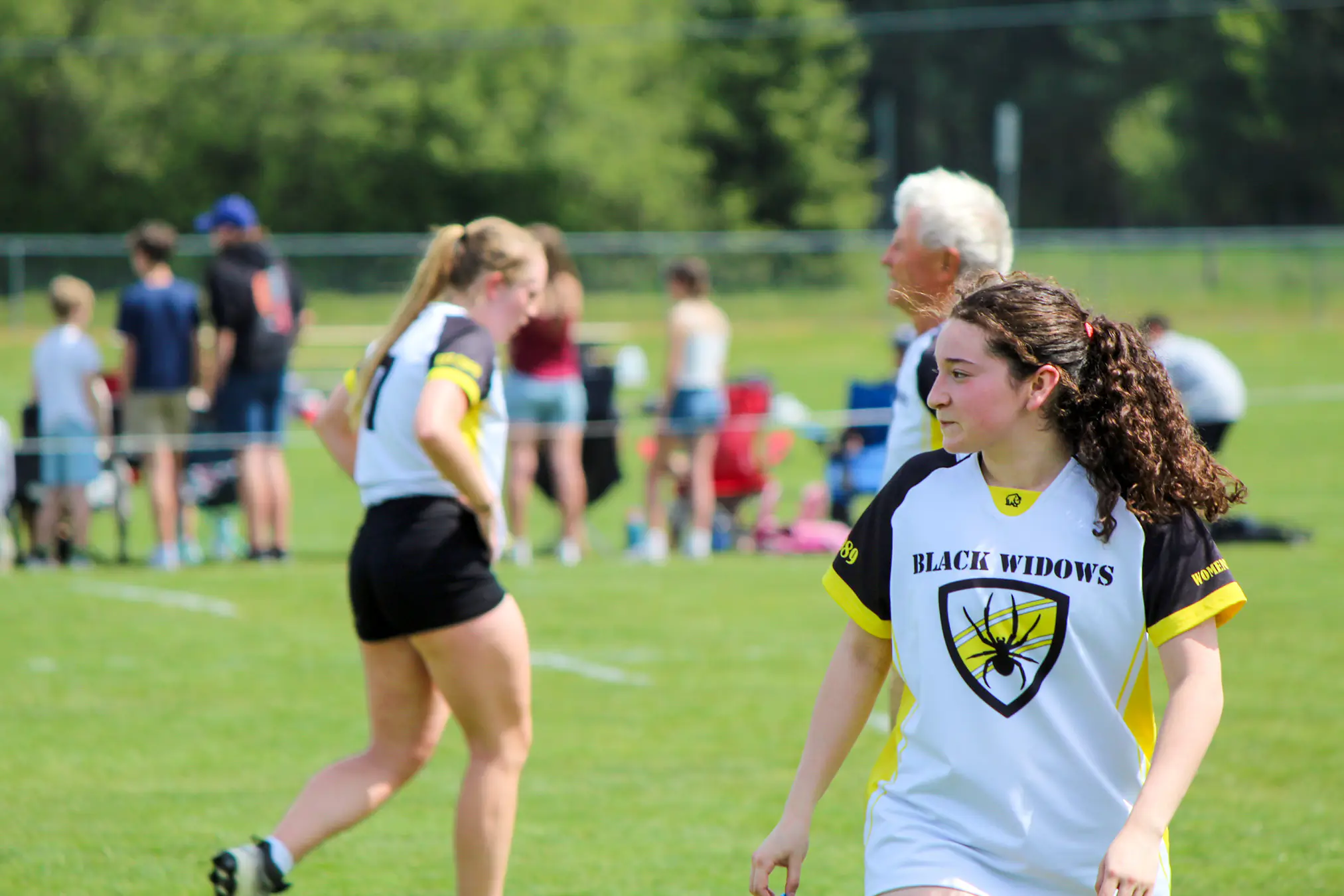 Action shot of the women's rugby club during a match on the outdoor field.