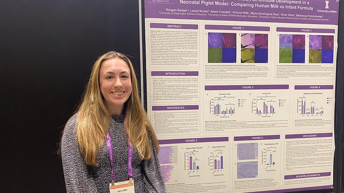 Reagan Badger stands next to her research poster.