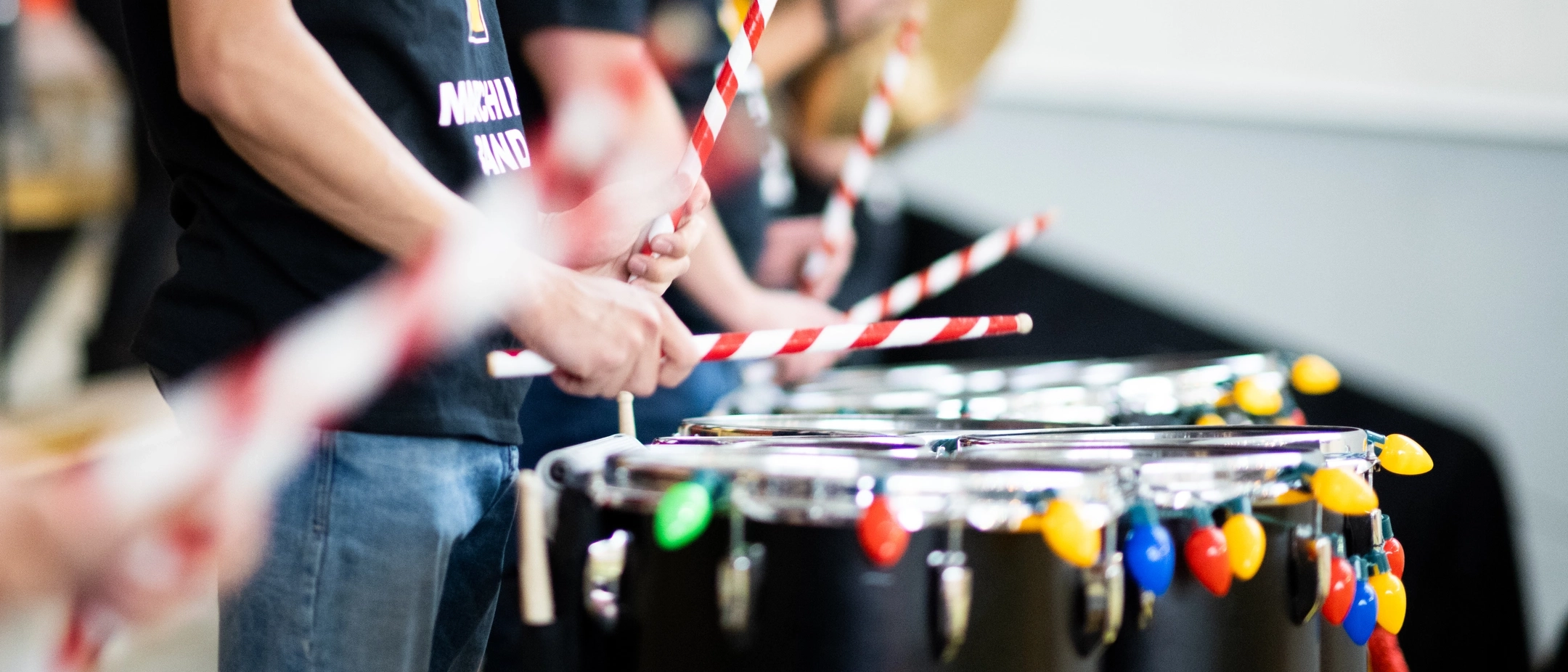 A band using candy cane inspired drumsticks during a performance