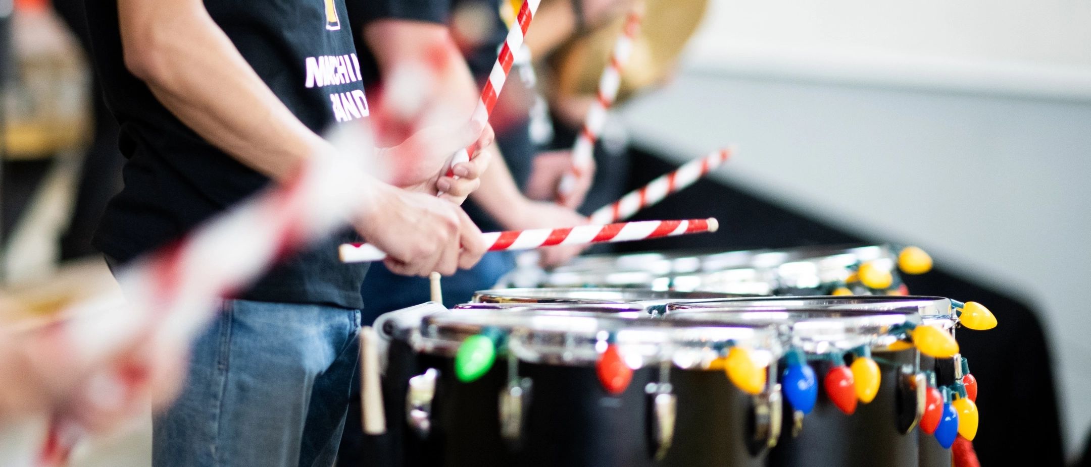 A band using candy cane inspired drumsticks during a performance