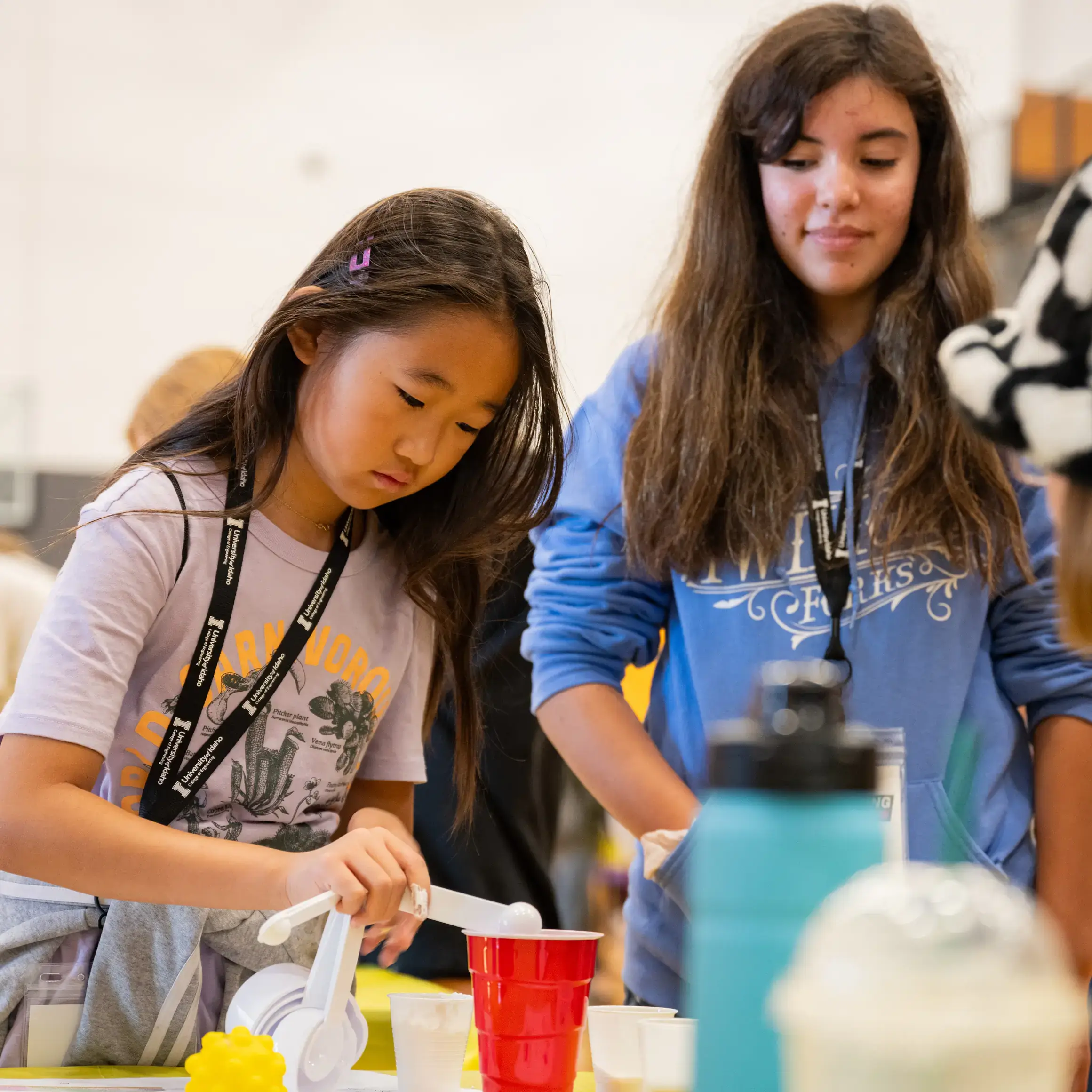 Two girls performing experiments during WIE Day