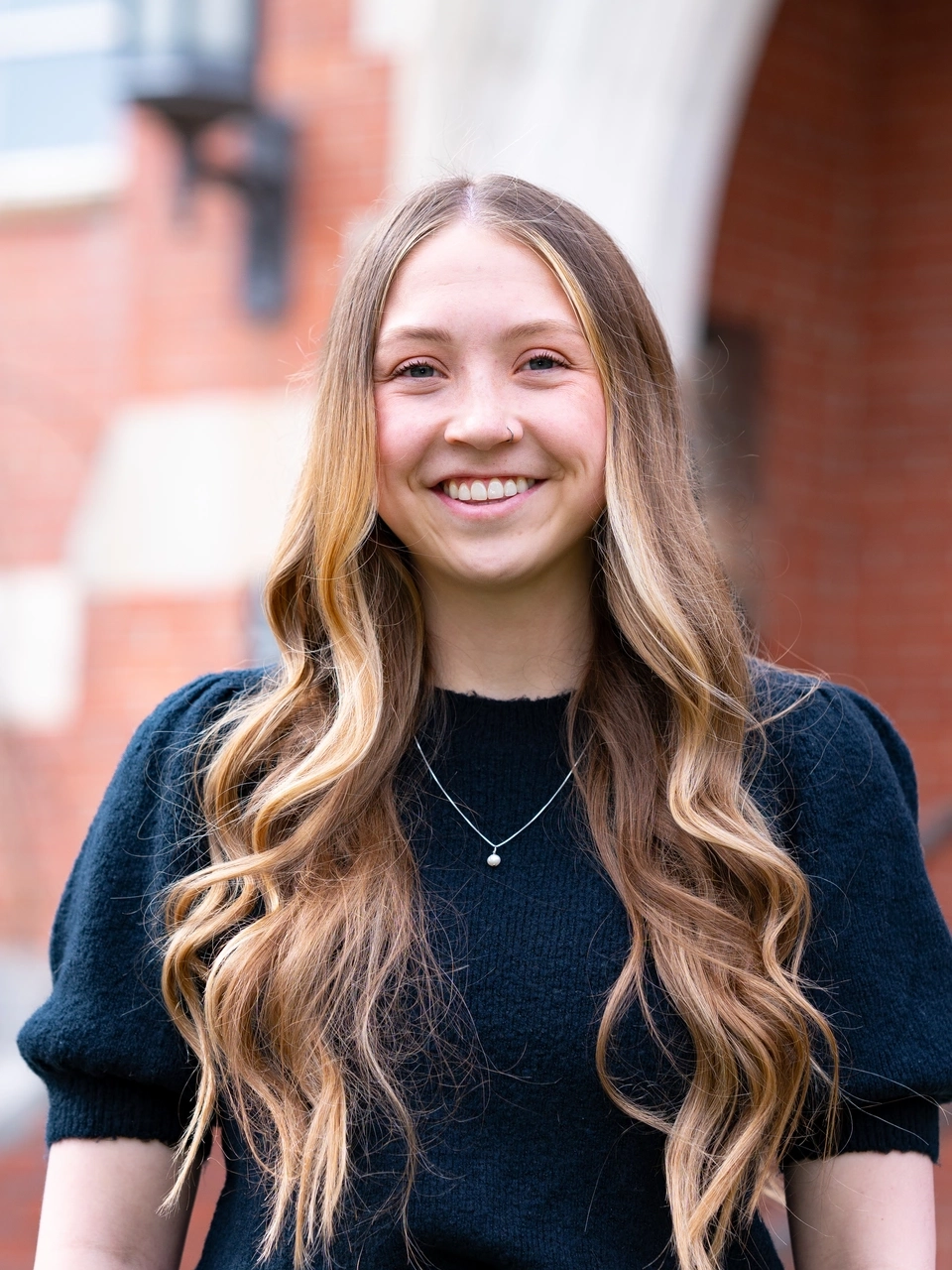 A portrait of a woman outside a building on the University of Idaho campus.