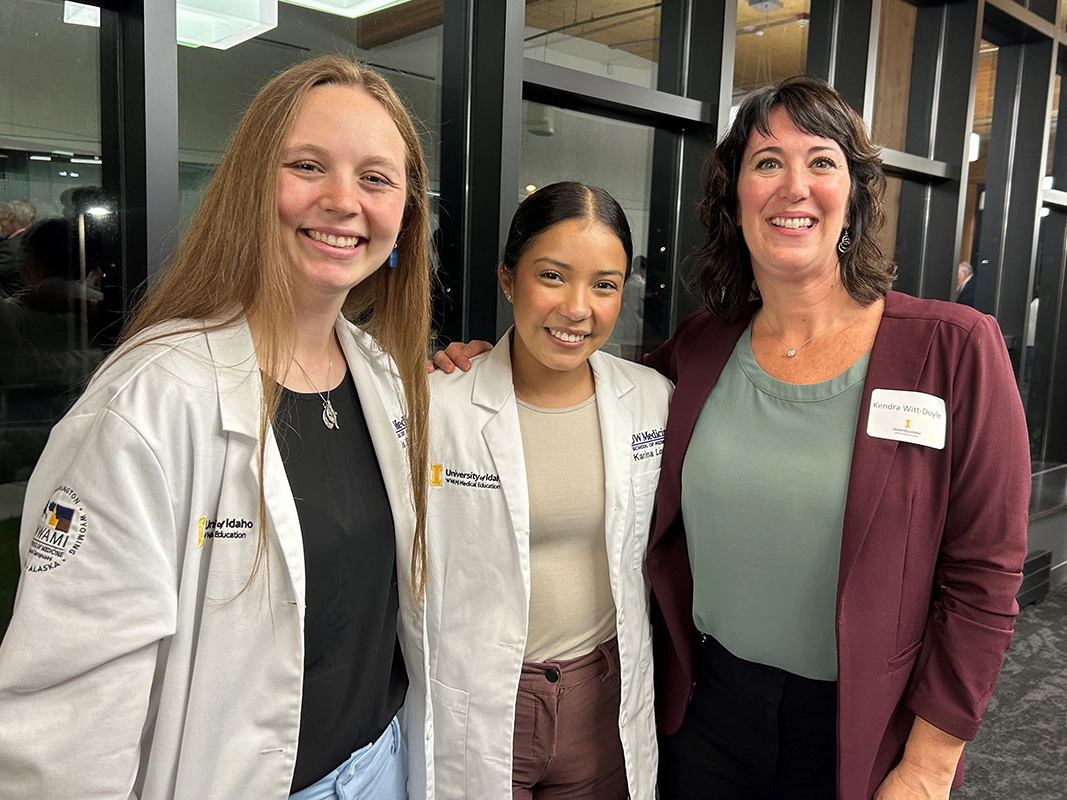 Three women standing together and smiling