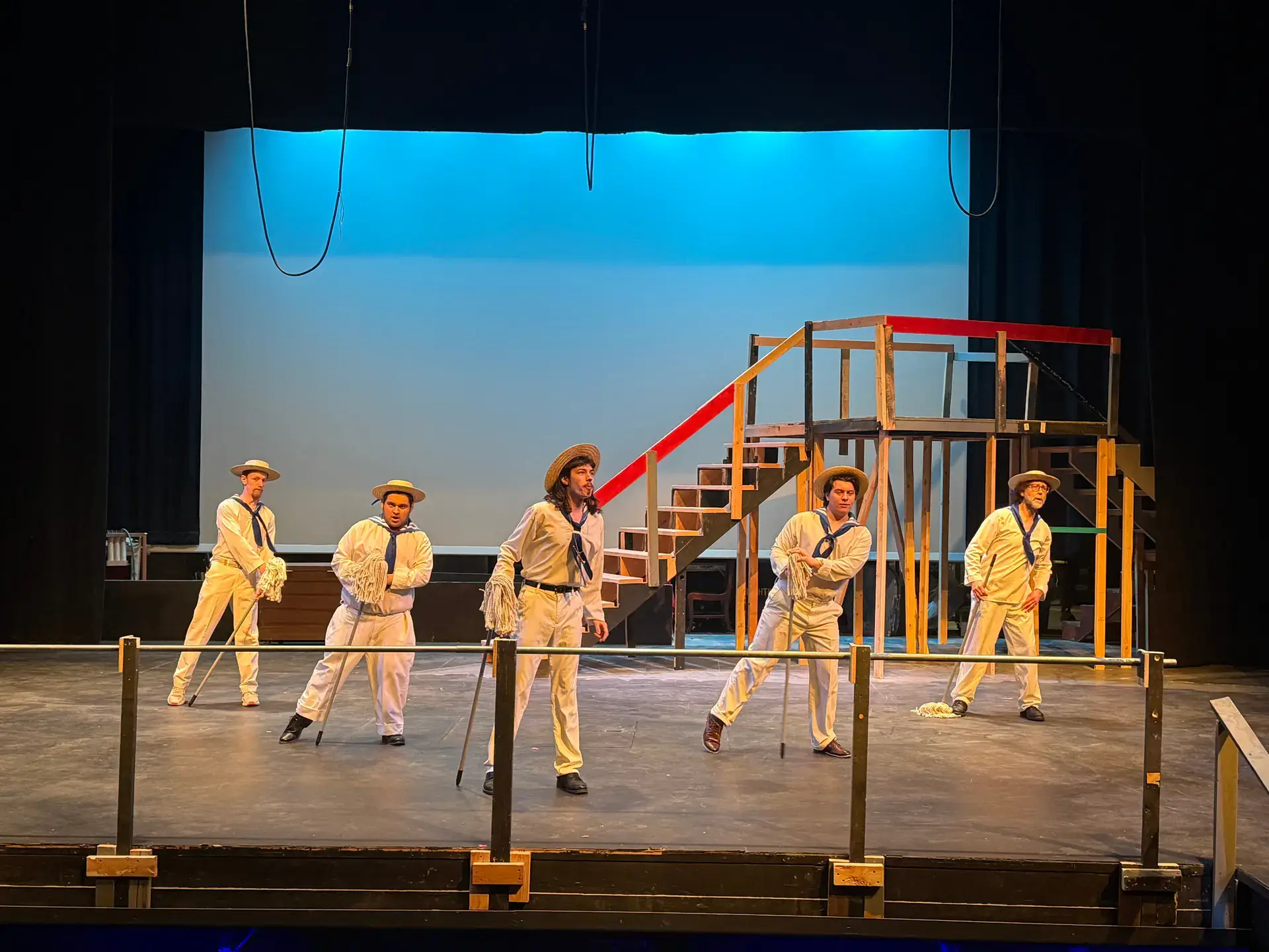 Five cast members of “H.M.S. Pinafore,” dressed as sailors, dance in a dress rehearsal in the Hartung Theater. 
