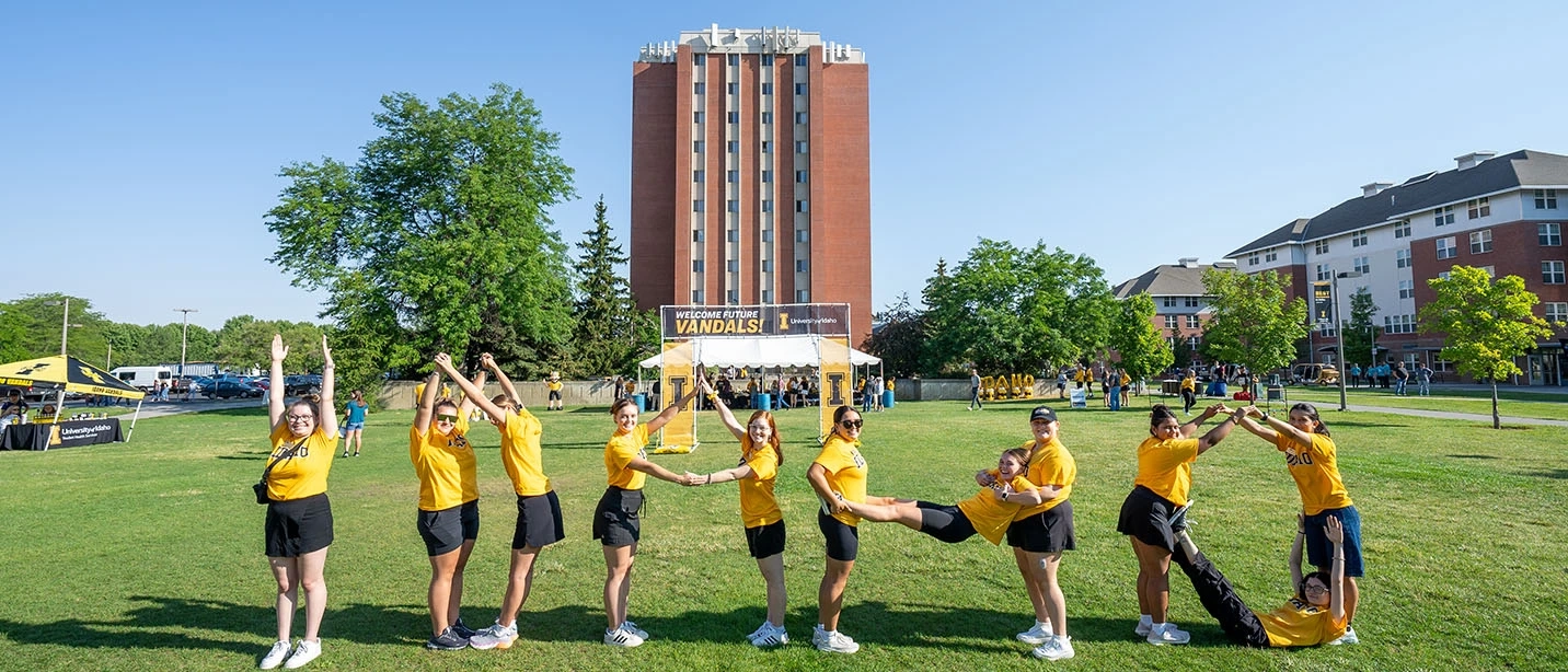 Students posing in ways that their bodies collectively spell the word idaho