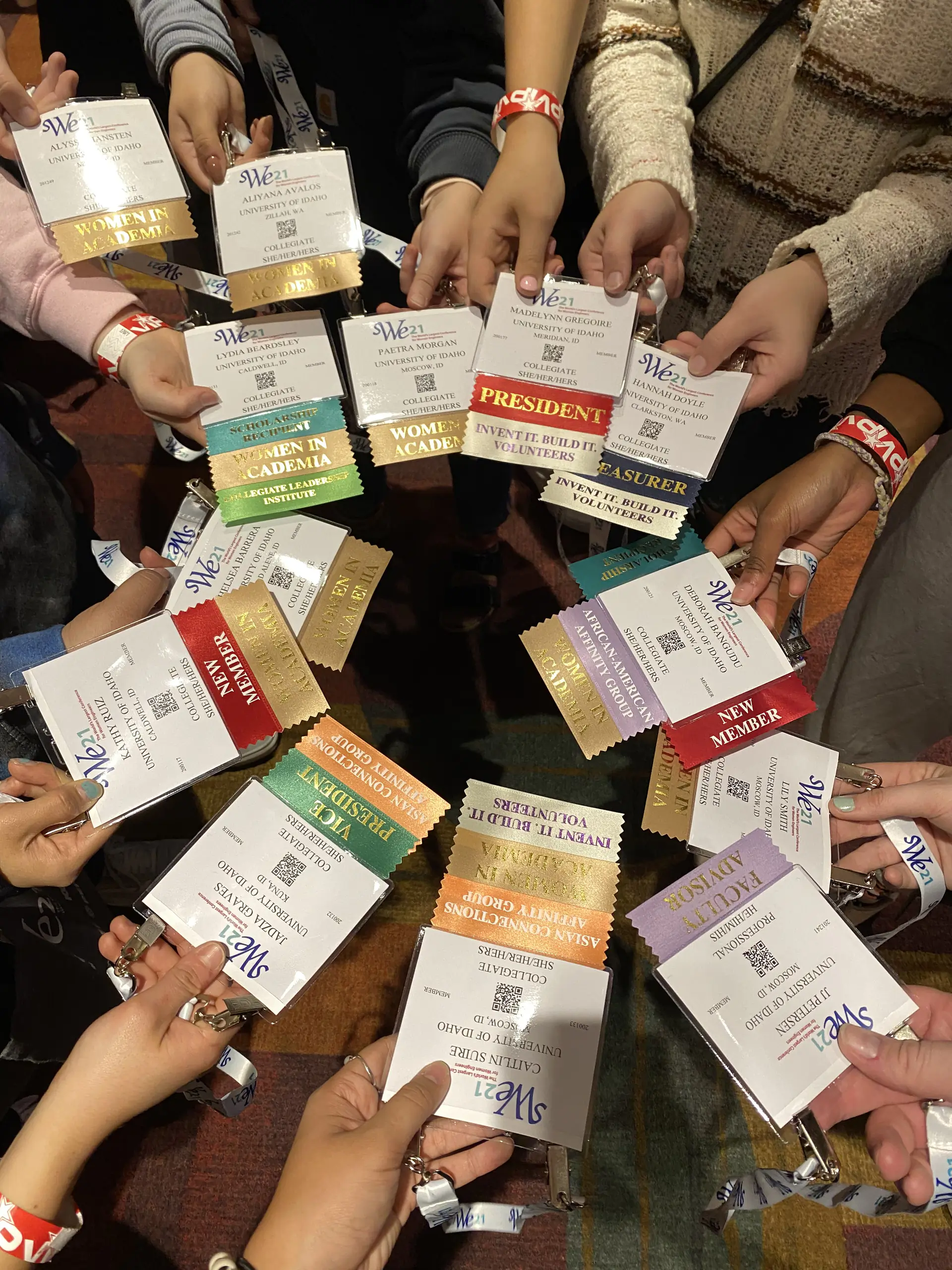 People holding out booklets in a circle