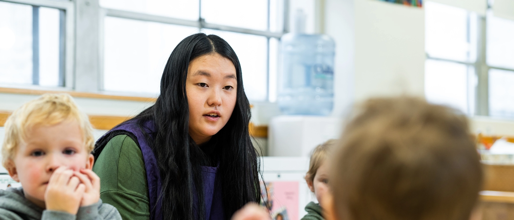 student teacher interacting with classroom children