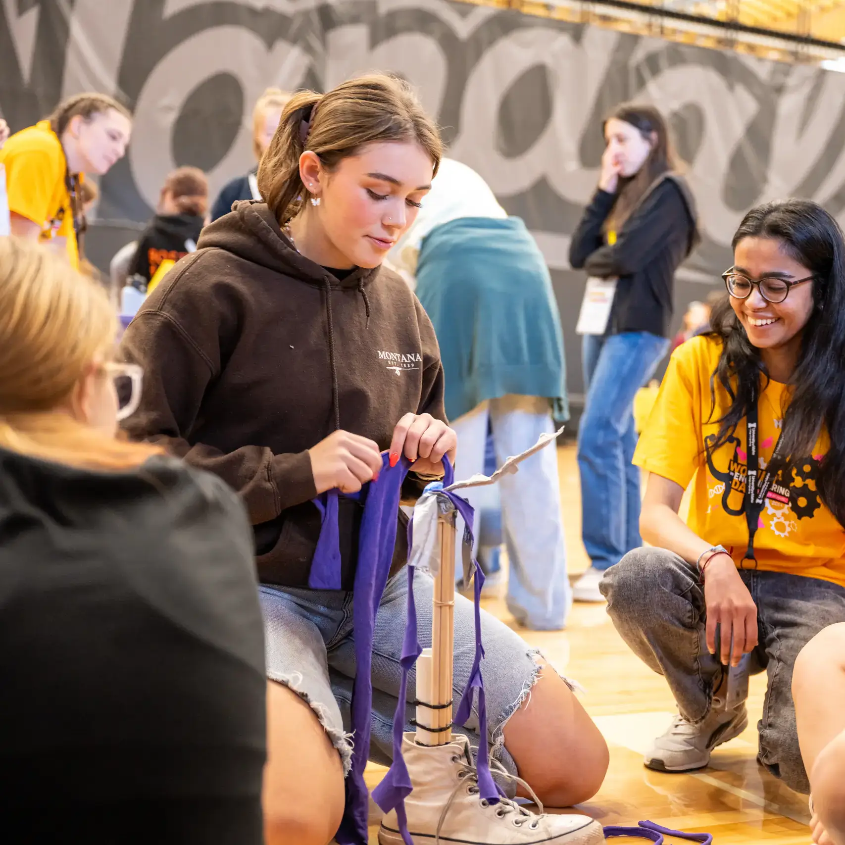 Students crowd around limb experiment