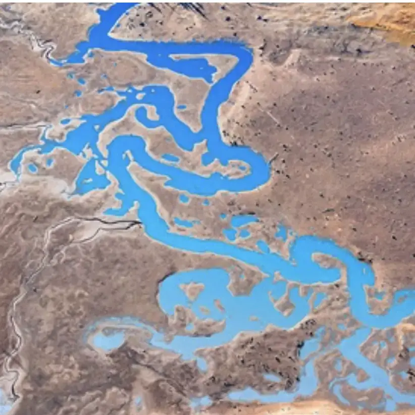Aerial photography of a blue river by Bill Woolston