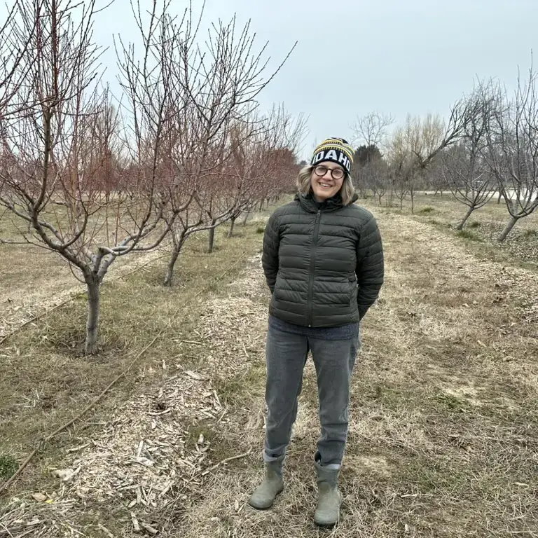 A woman in an orchard