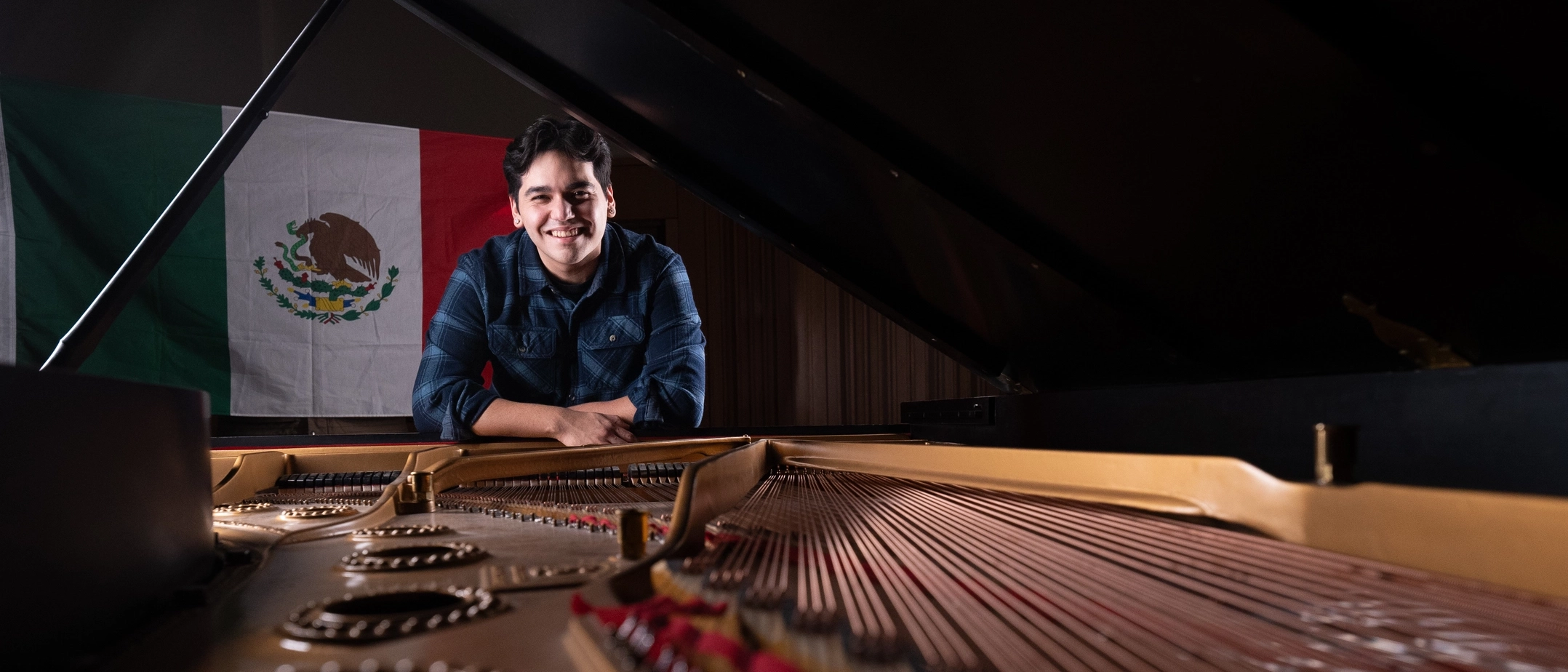 Alex Aguilar plays the piano in the Haddock Recital Hall at the Lionel Hampton Music Building
