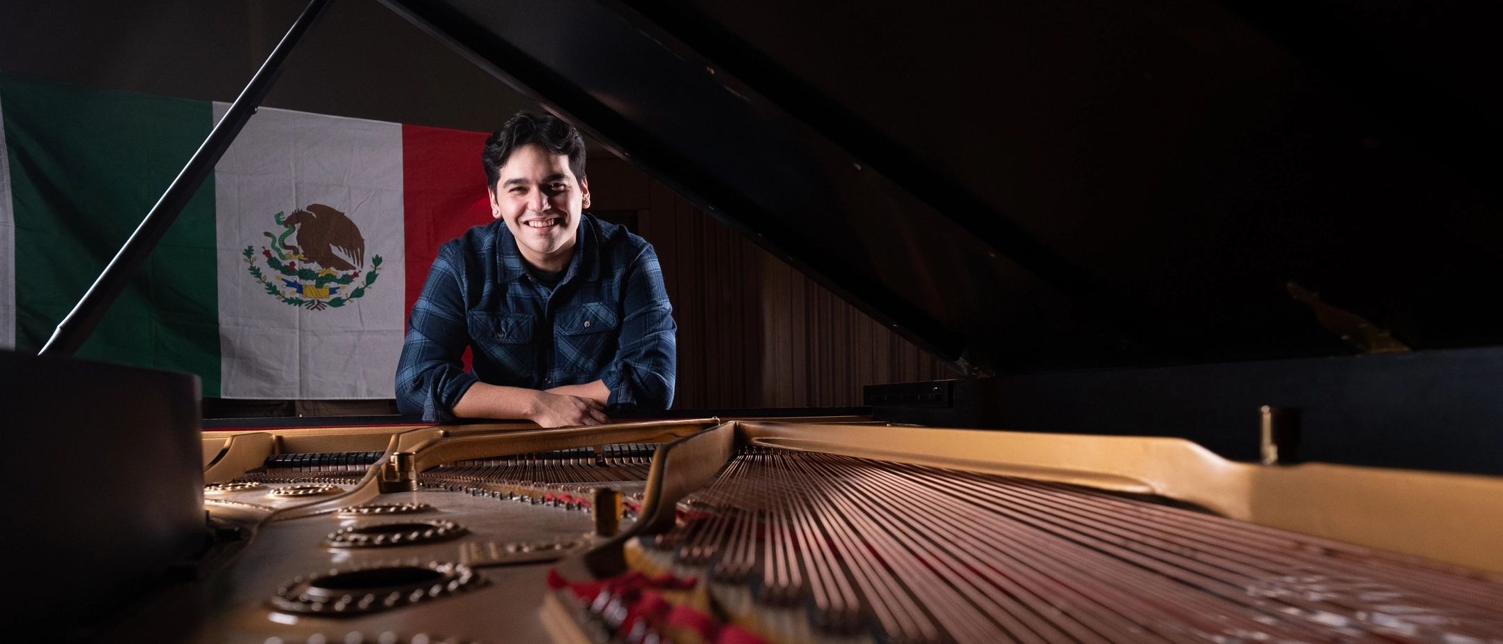 Alex Aguilar plays the piano in the Haddock Recital Hall at the Lionel Hampton Music Building