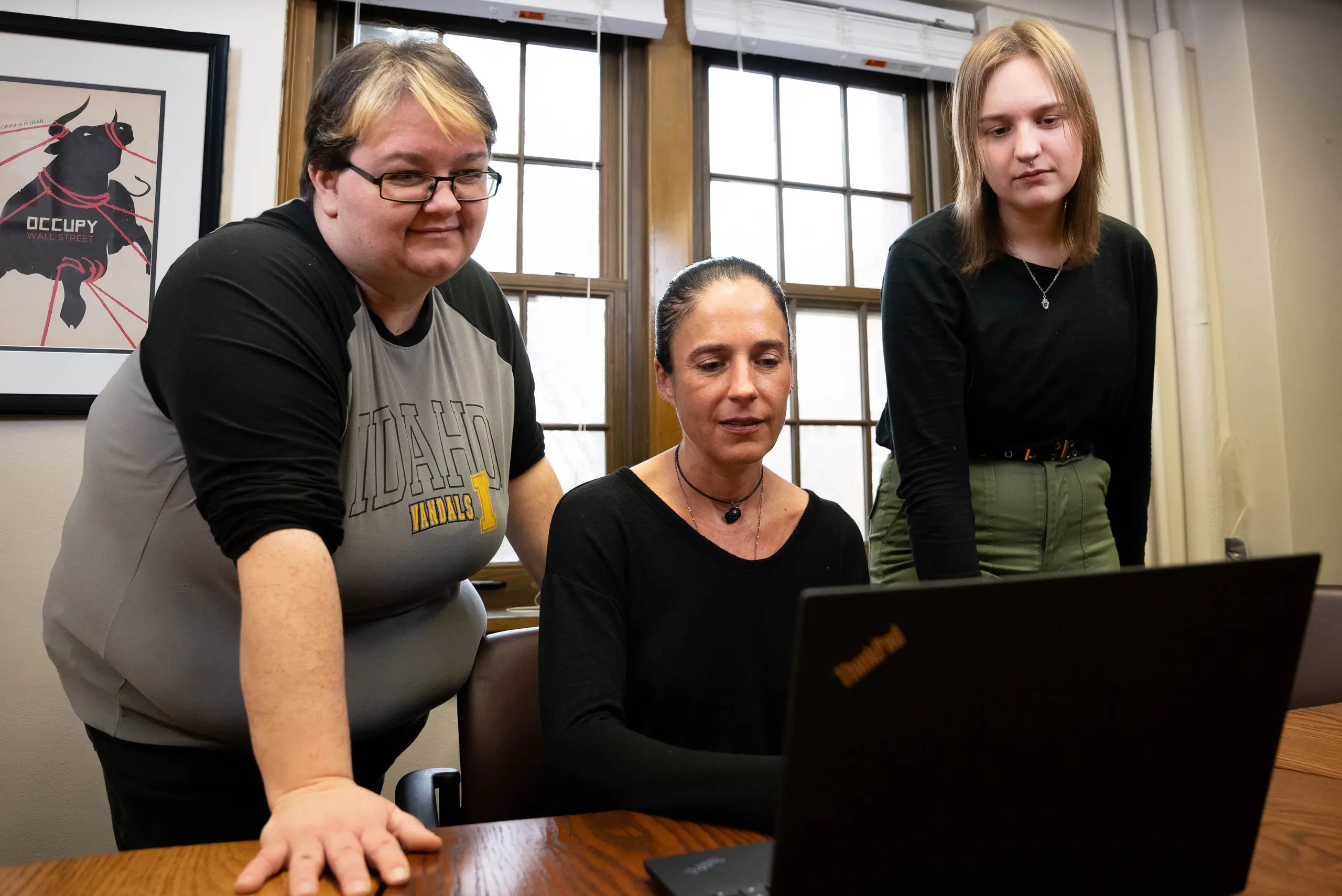 Portrait of three people with laptop.