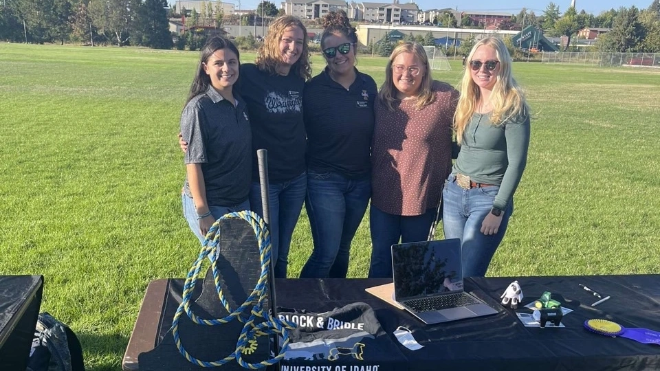 Five ladies behind a display table for the Block and Bridle club