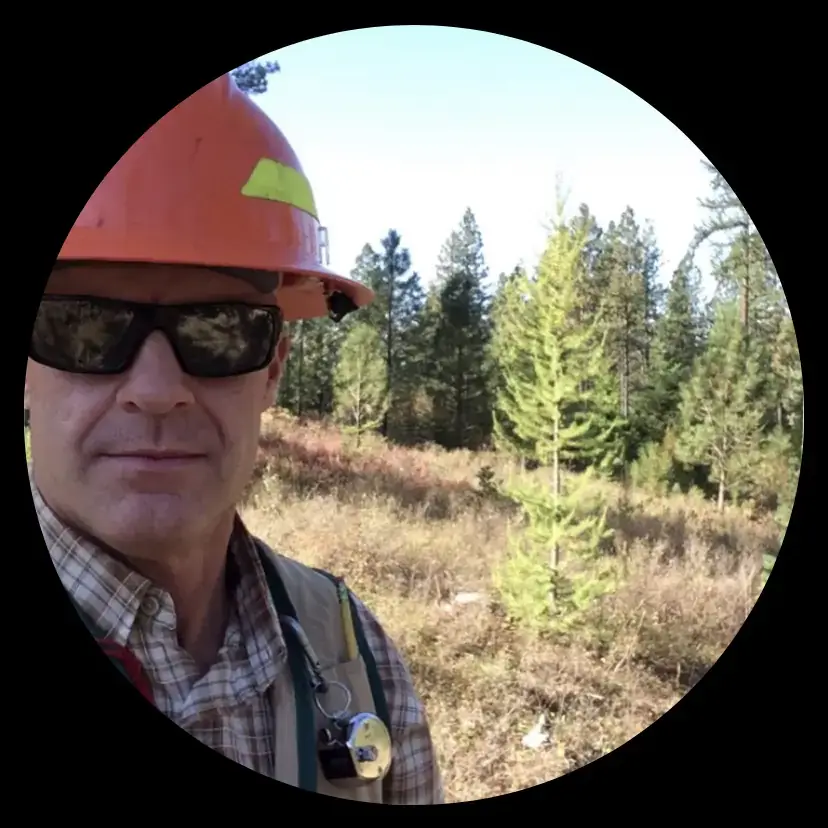 Randy Brooks in a hard hat in the woods