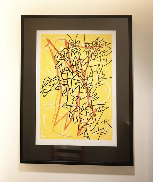 Loose white circles cut through a yellow background, atop which is an angular figure in red. On the topmost layer are thin, bold lines, implying a mass of stacked figures in a column.