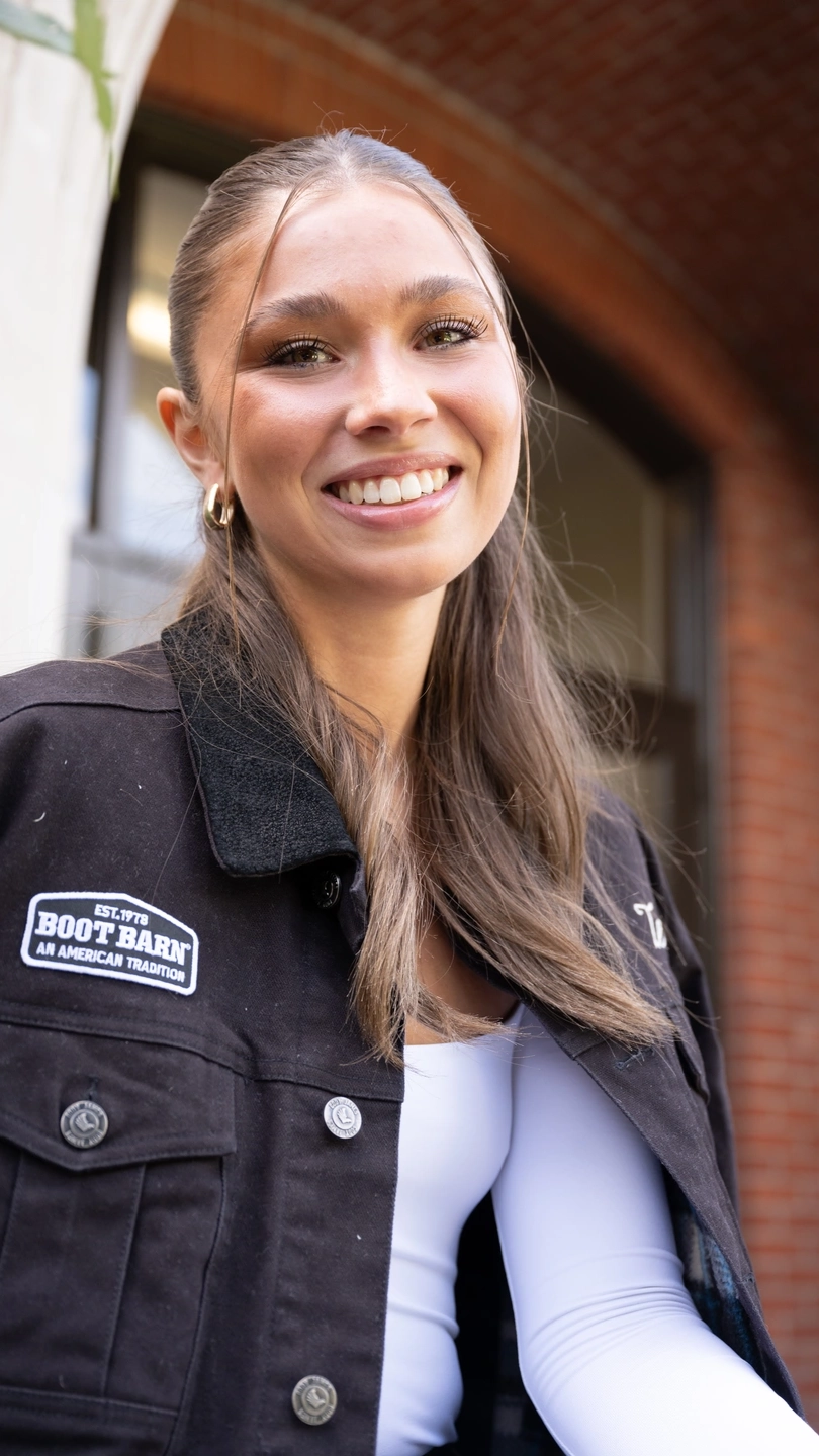A portrait of a woman wearing a black jacket.
