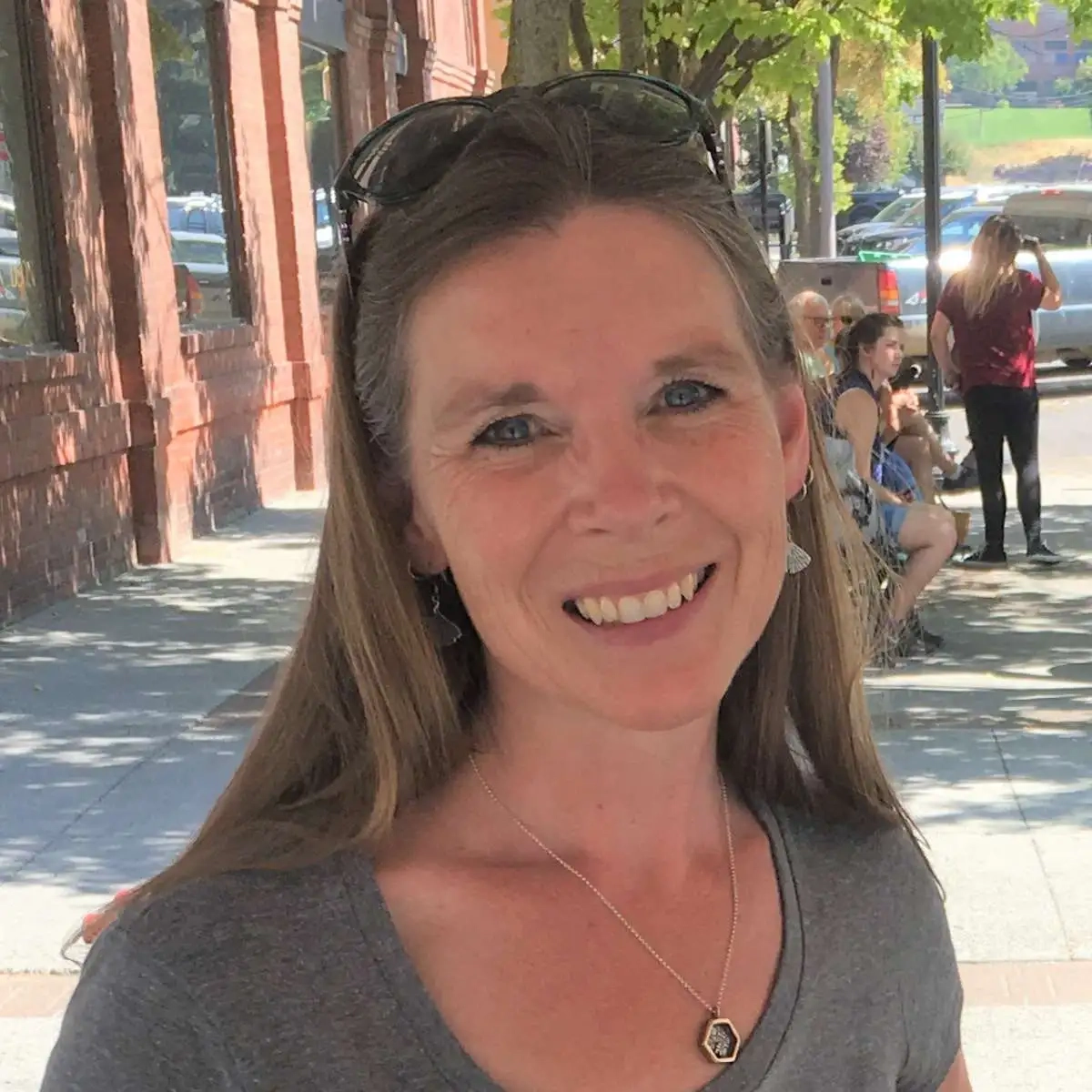 A portrait of a woman on a sidewalk