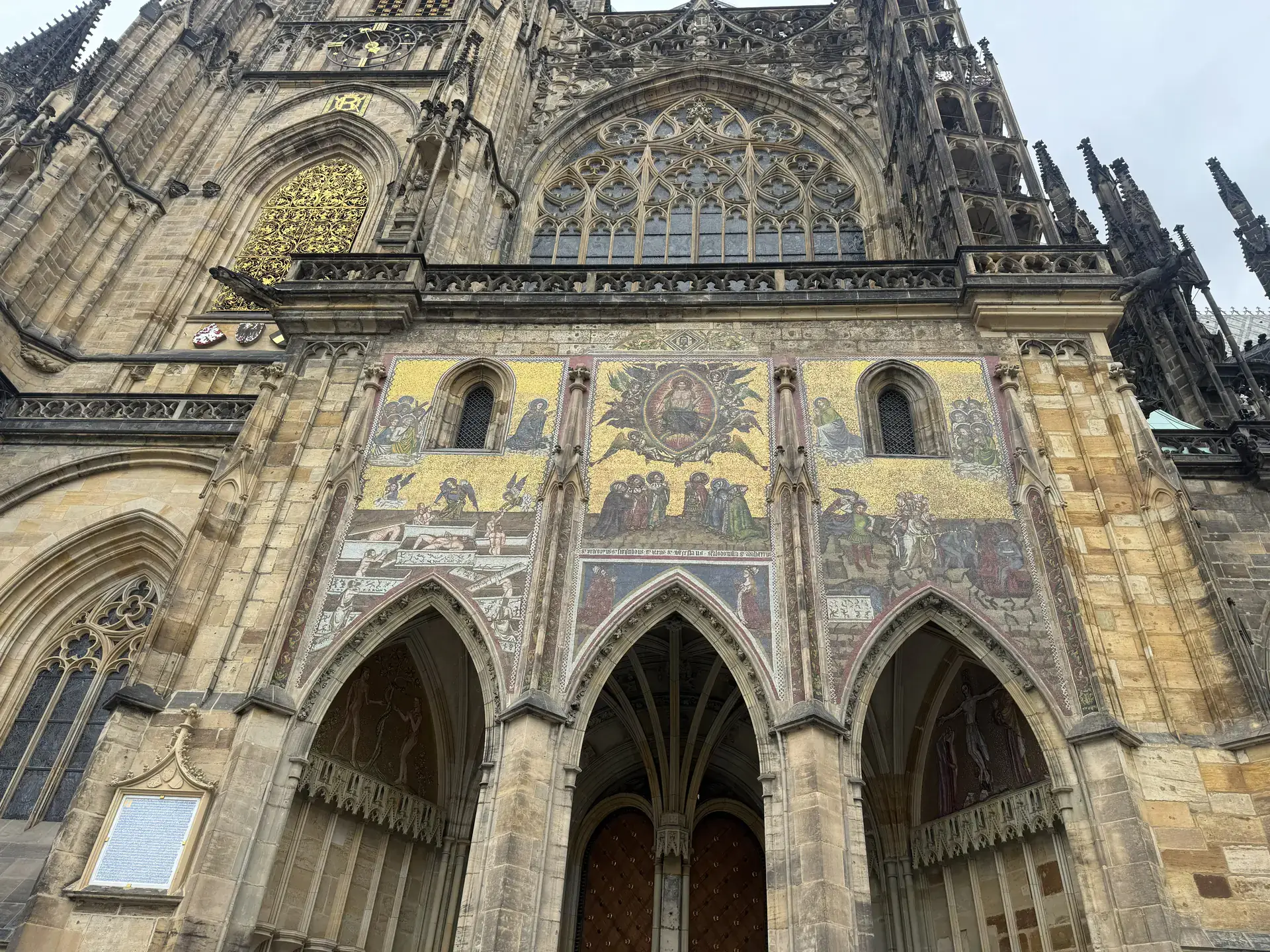 St. Vitus Cathedral, old gothic church with mosaics on the front, in Prague.